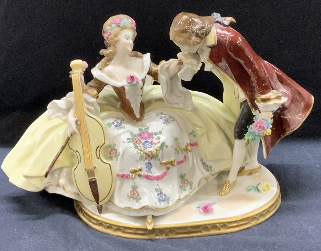 Scheibe Alsbach Porcelain Couple Statue Germany: Measures approx 6 1/2 in by 10 in by 4 1/2 on. Scheibe Alsbach porcelain statue of an 18th century courting couple. Made in Germany. Hallmarked with the Kister Mark in blue ink under glaze and impress