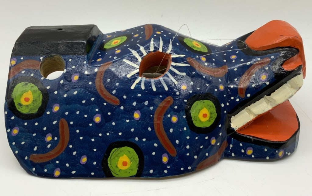 Hand Carved & Painted Wooden Animal Folk Art Mask: Hand carved wooden animal mask, hand painted with green and purple dot under an indigo blue with a red mouth. Approximately 9 inches long and 7,25 inches wide. Moderate wearing due to age and use. Car