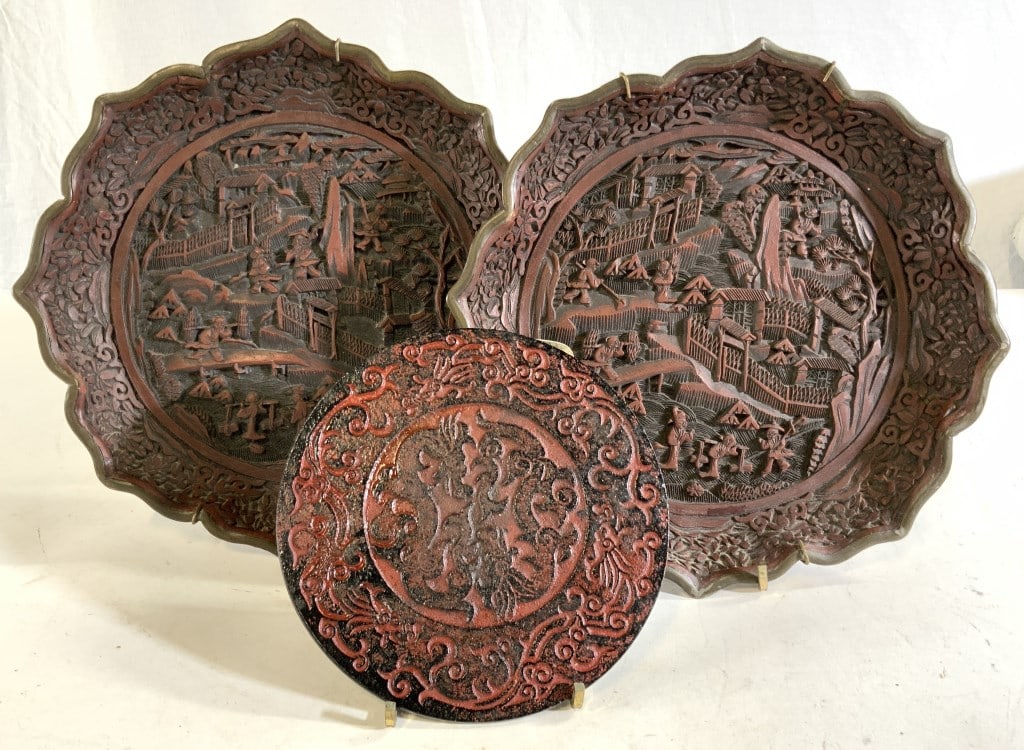 Group 3 Iron Asian Display Plates and Trivet: Chased Iron trivet painted in brick red, each foot is covered in non slip rubber , 5.5 in., Pair wall plates in iron ( or other metal) covered in composite that creates the images of Asian life , flor