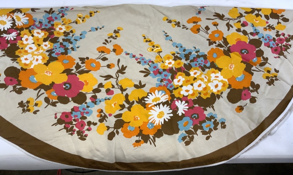 ULRIK Round Tablecloth w Pop Art 1960s Flowers: Round tablecloth , 60 in. textured man made fabric . Tan tablecloth with Brown border and brilliant 1960s pop art flower design colors of fuchsia, orange, saffron , aqua, and white. Appear to never ha