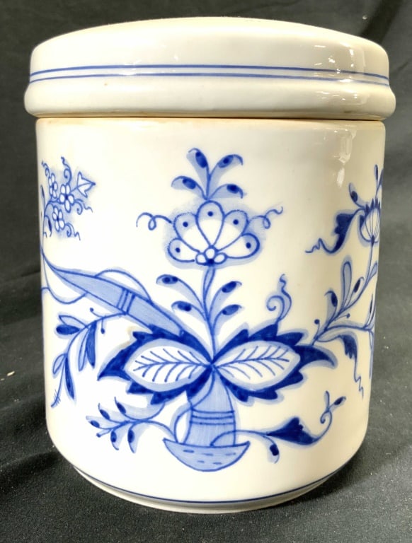 Vintage Lidded Floral Porcelain Jar: Trademark appears to possibly be MEISSEN. Jar is white with blue toned floral detail. Piece is porcelain. Jar includes lid. Piece measures approx 5.5 inches tall 4.5 inches wide. Porcelain jar, lidded