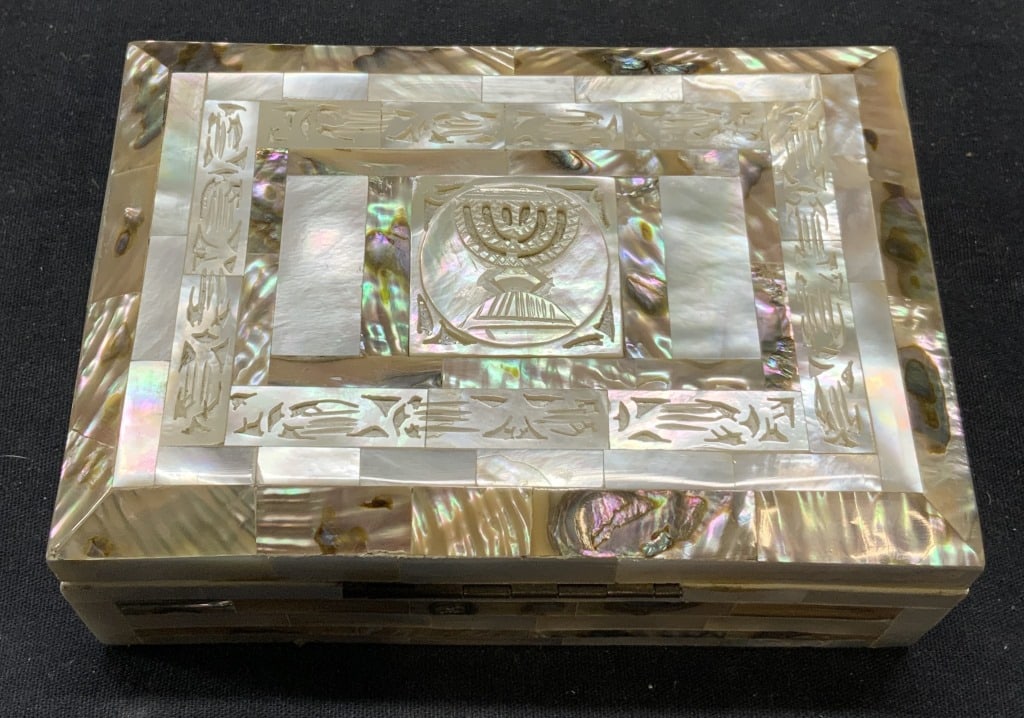 Mother of Pearl Judaica Jewelry Box: Inlaid and carved mother of pearl decorated jewelry box with menorah motif. Some surface wear consistent with exposure. Measures approx. 5.25 x 3 5/8 x 1.75 inches. Jewelry box, menorah jewelry box, j