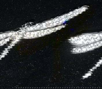SWAROVSKI Crystal DRAGONFLY Brooch: Signed SWAROVSKI Dragonfly brooch, hallmarked with swan logo. Clear crystals set in silver tone metal. Brooch measures 1.75 x 1.5 in. Swarovski crystals are valuable because of the high quality of the