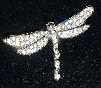 SWAROVSKI Crystal DRAGONFLY Brooch: Signed SWAROVSKI Dragonfly brooch, hallmarked with swan logo. Clear crystals set in silver tone metal. Brooch measures 1.75 x 1.5 in. Swarovski crystals are valuable because of the high quality of the