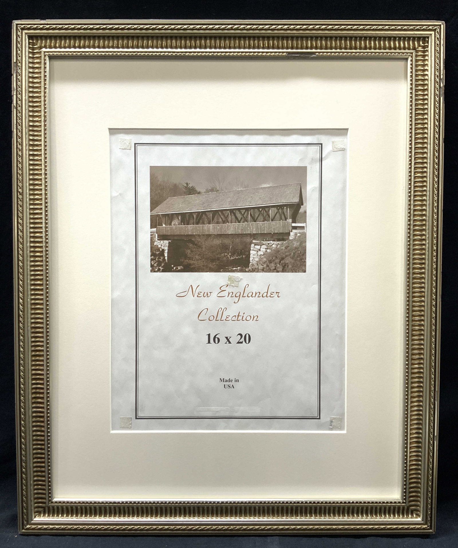 New Englander Collection 16 x 20 Wooden Frame: Marked on center New Englander Collection, 16 x 20 Silver toned ornate frame with off white mat board. Approximately 22.5 x 19 inches, Moderate wearing and loss to edges of frame. No glass. Ornate fra