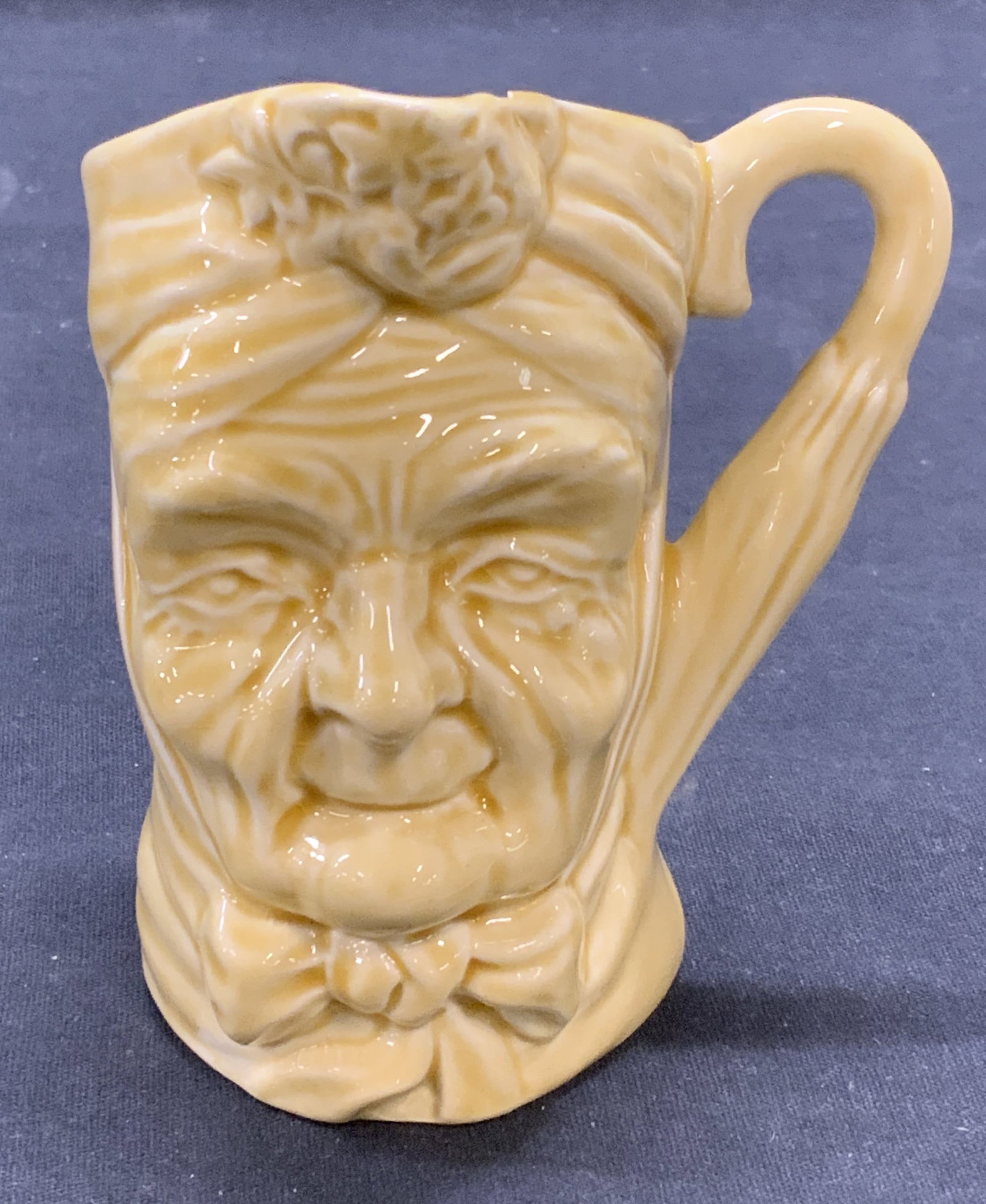 Vintage Sterling Ceramic Granny Toby Jug England: Vintage Sterling ceramic granny figural Toby jug. Trademarked to underside. Made in England. Measures approx. 3 x 3.5 x 3.25 inches. Some surface wear consistent with exposure. Chip to rim observed. S