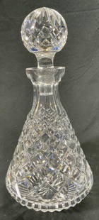 WATERFORD Cut Crystal Decanter With Stopper: Underside is signed WATERFORD. Decanter is cut crystal. Piece has geometric relief detail. Decanter includes stopper. Piece measures approx 10.75 inches tall 5.25 inches wide. Decanter, decanter with