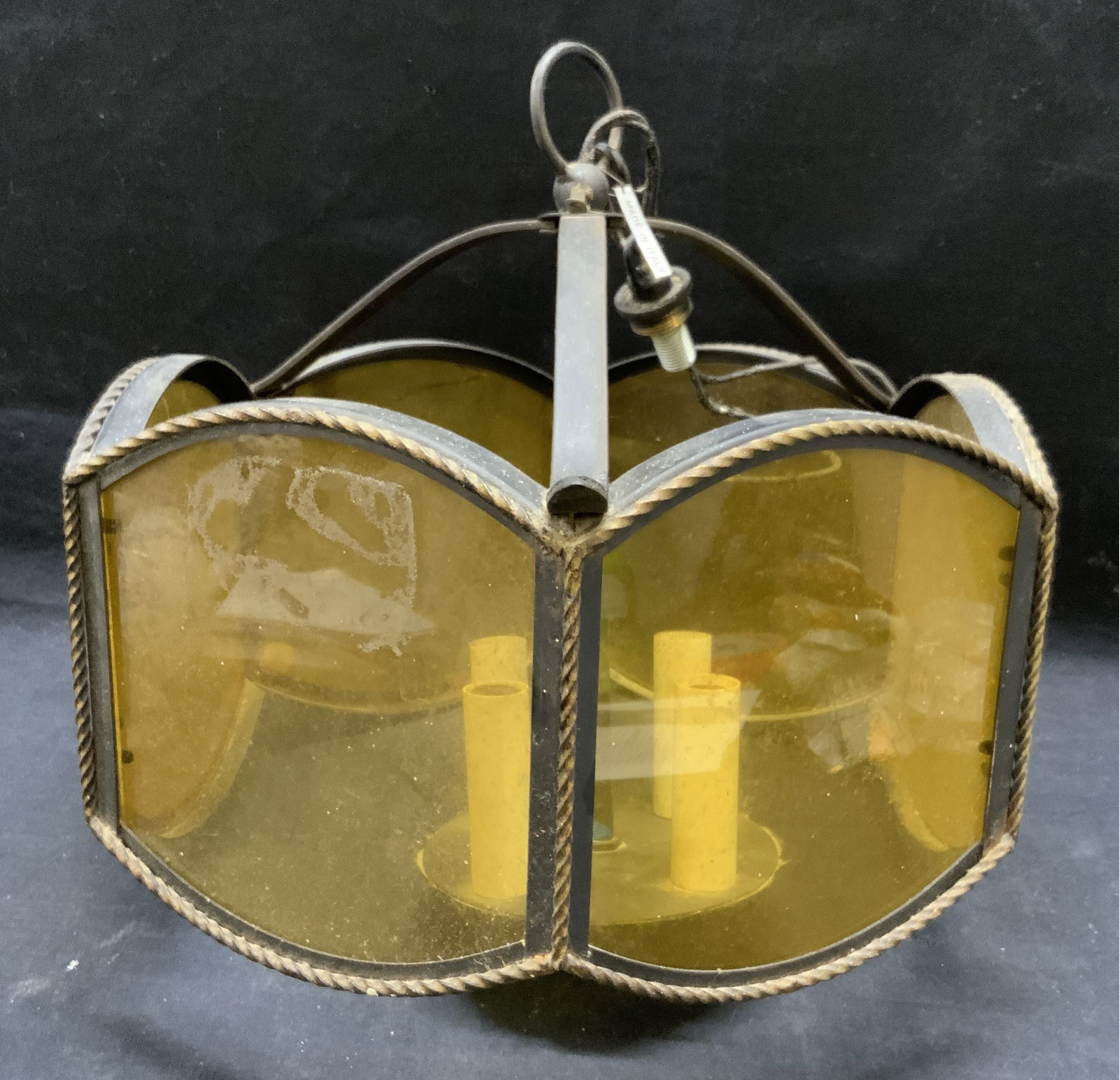 Iron & Glass Chandelier Light Fixture, Italy: Iron and amber glass hanging chandelier light fixture. Not tested for function. Made in Italy. Marked Italy on tag. Surface wear consistent with exposure. Piece has weight, measures approx. 13 x 10 in
