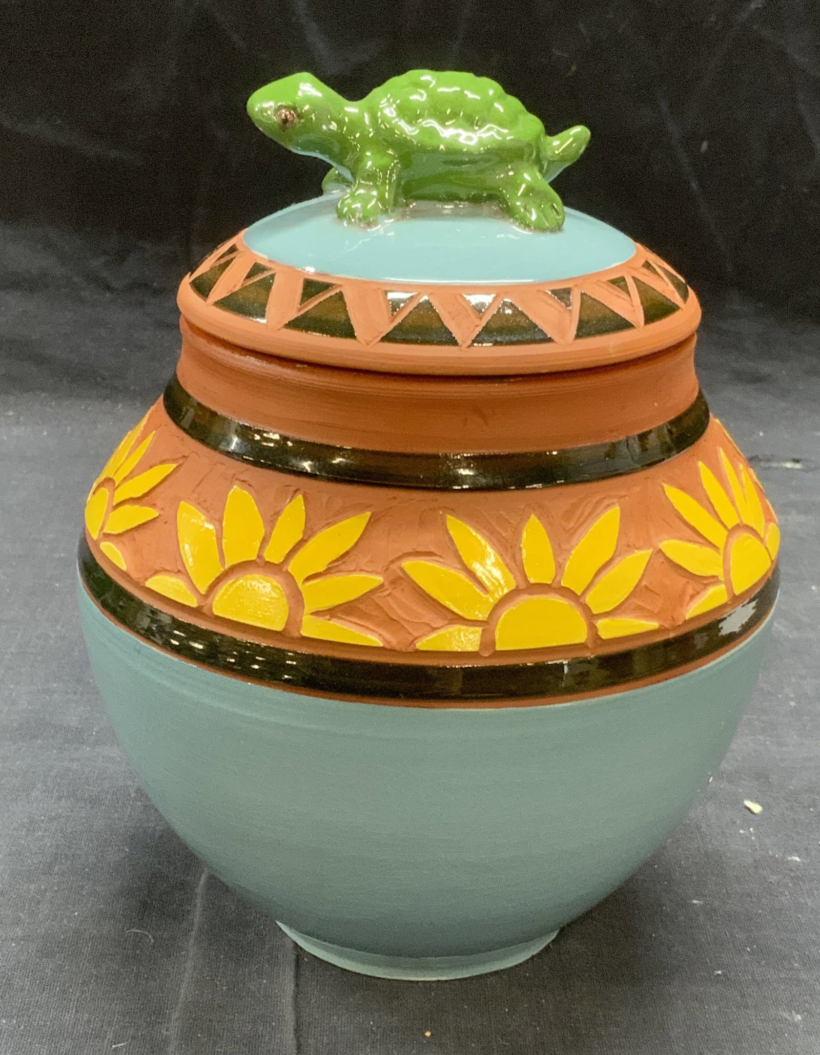 POTERE Vintage Terracotta Pottery Lidded Bowl: Signed vintage terracotta pottery lidded bowl with sun motif and turtle finial in blue, green, and yellow. Marked The POTERE to underside, 1996. In good condition, crazing observed. Measures approx. 6