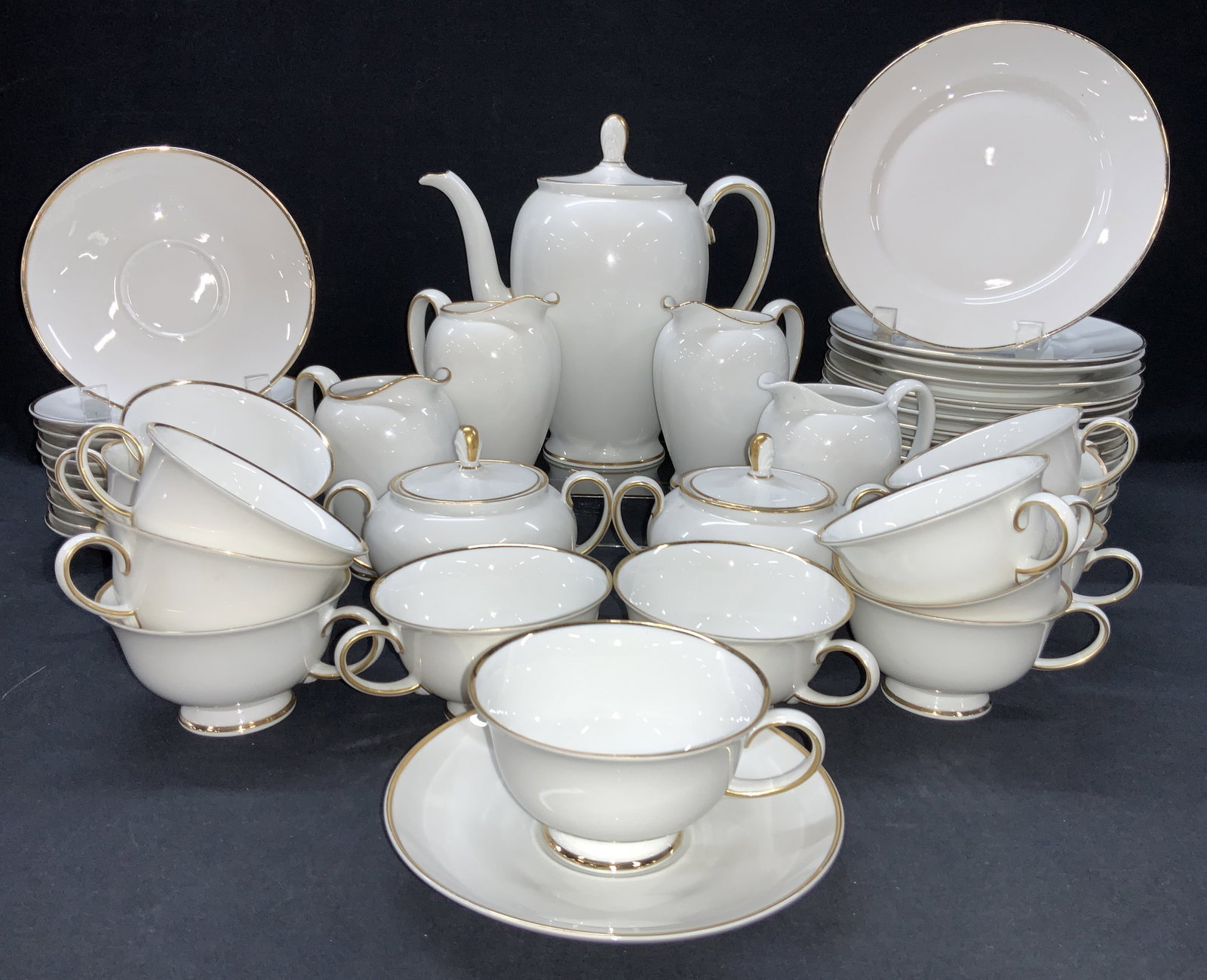 Set 51 Rosenthal Gilt Porcelain Dishware, Germany: Set of 51 dishware, all marked Rosenthal. Consists of 17 dishes at 7.5 inch diameter. 12 Saucers at 6 inch diameter. 4 creamer pitchers at 4.5 inches tall. 1 coffee pot. 2 sugar bowls with lids and 15
