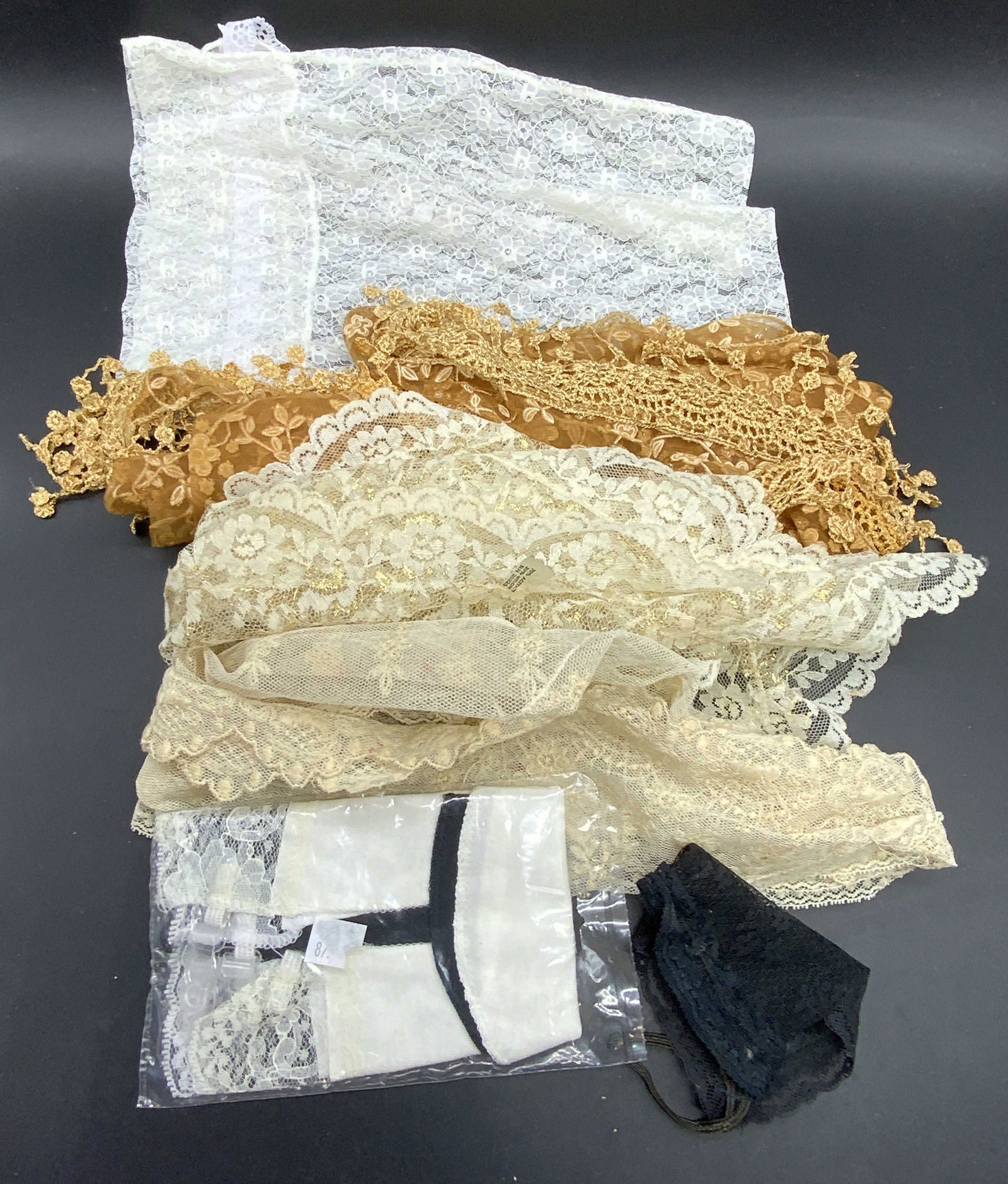 Lot 6 Lace Accessories, Bag, Scarf, & More: Six lace accessories. Lot includes lace scarves, a lace bag, and other lace items. Pieces are primarily white, black, and beige hues. White lace bag Measures approx. 13L x 9W in. Some discoloration an