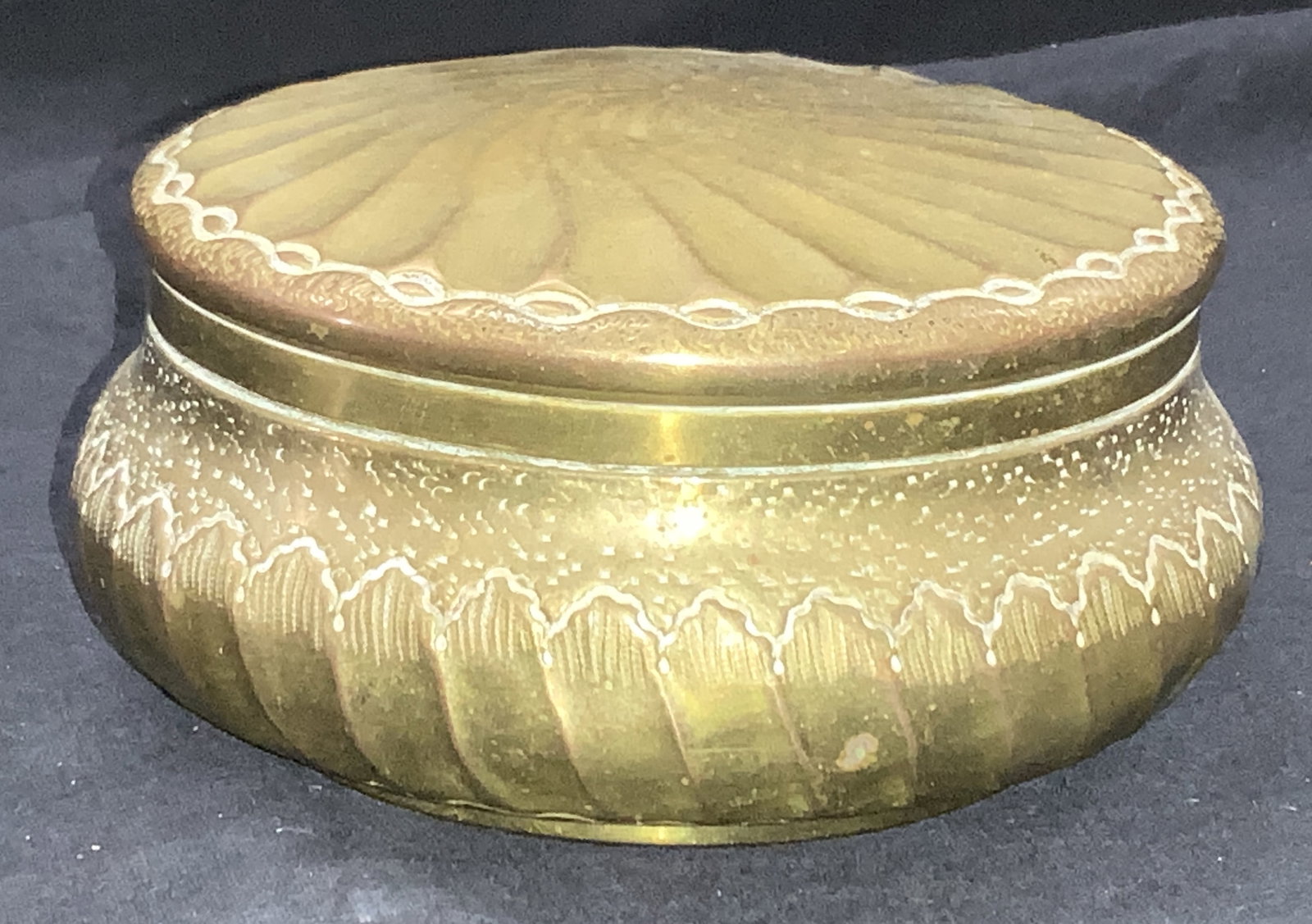 Vintage Etched Brass Trinket Box: Vintage brass made trinket box, circular in shape with raised spiral on lid and etched designs on Body. Approximately 3.25 inches tall and 5 inch diameter. Moderate surface wearing and residue on inte