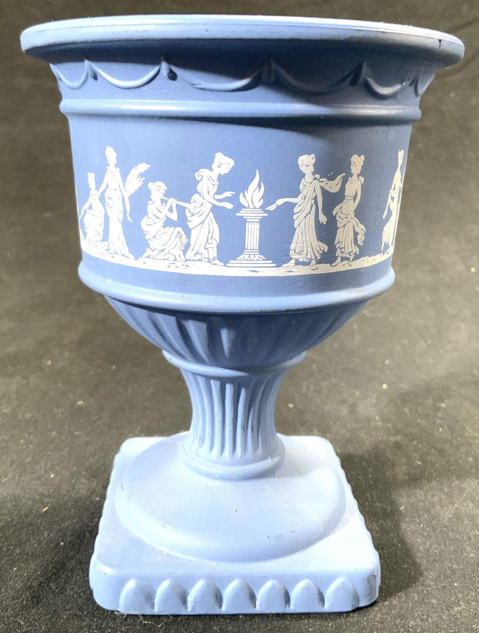 AVON Jasperware Style Goblet Vessel: Vessel reads AVON on underside. Goblet is blue & white toned with Jasperware Wedgwood style. Piece has depiction white toned female figures. Vessel measures approximately 5 inches tall 4 inches wide.