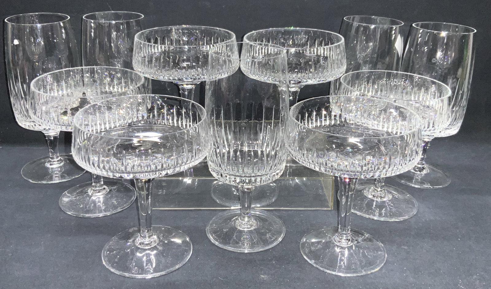 Set 11 Cut Crystal Stemware: Set 11 crystal stemware, consisting of 6 martini glasses, at 5 inches tall and 4 inch diameter and 5 flutes at 6.5 inches tall and 2 inch diameter. Each cup has vertical grooves on exteriors. Minor su
