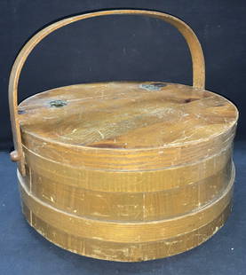 Antique Wooden Shaker Sewing Basket: Antique wooden shaker sewing basket with hinged top handle and lid and posts on interior for spools of yard. approximately 7.25 inches tall and 15 inch diameter. Top handle drop is approximately 6 inc