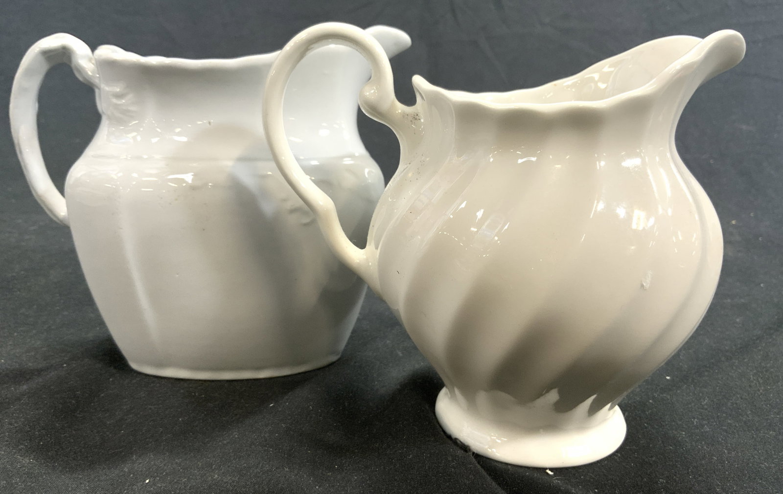 Lot 2 Vtg Porcelain Creamer Dishes Vessels: One creamer is marked ROYAL IRONSTONE CHINA W H GRINDLEY & CO ENGLAND, the other reads MADE IN ENGLAND. Each piece is white toned and porcelain. One creamer has scalloped exterior. Largest vessel meas
