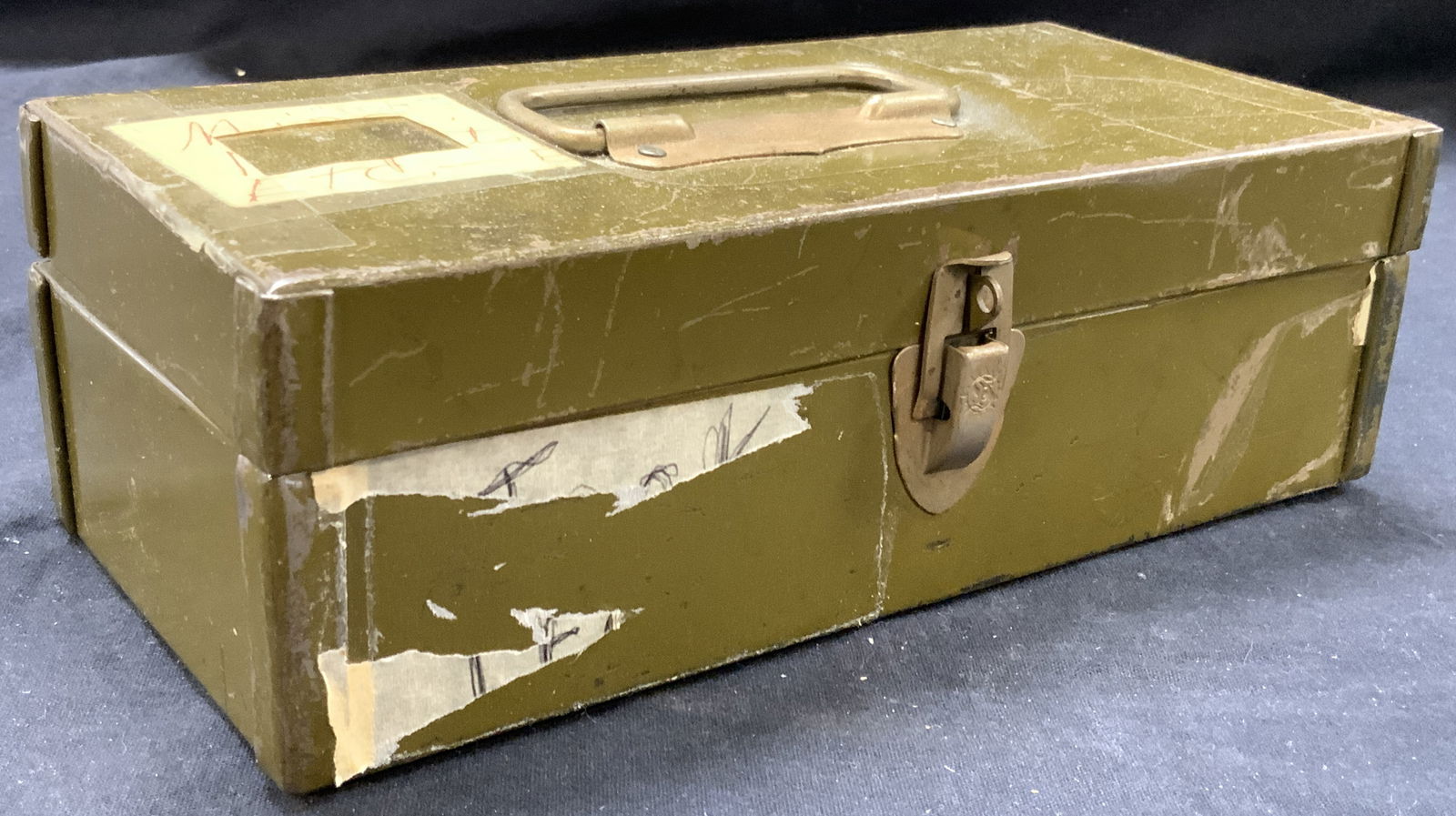 Vintage Latches Metal Storage Box: Vintage olive green toned metal latch box with top handle. Approximately 9.5 x 4 x 3 inches. Evident wearing to box edges and with paper and tape residue. Latch box, metal storage box, metal box, smal