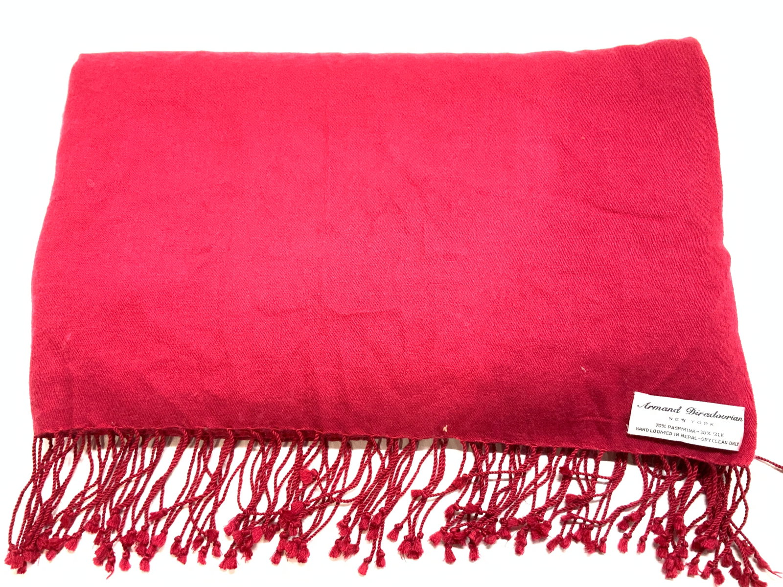 Armand Diradourian Pashmina Silk Shawl, Nepal: Hand Loomed red shawl with tassels, 80% pashmina, 30% silk. Designer label attached Armand Diradourian New York. 36 x 79 in. Light wear with some fabric fuzz consistent with material type and wear. Fa