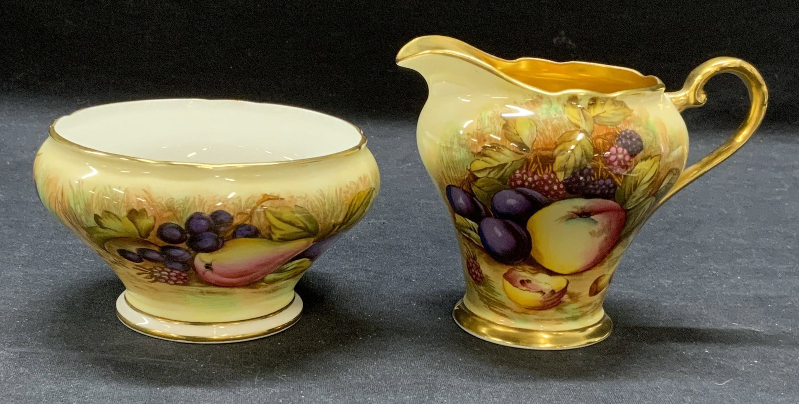 AYNSLEY China Sugar Bowl & Creamer: AYNSLEY bone china sugar bowl and creamer set in Harvest Gold pattern. Trademarked to undersides. Made in England. Some surface wear to each consistent with exposure. Creamer measures approx. 5 1/8 x 