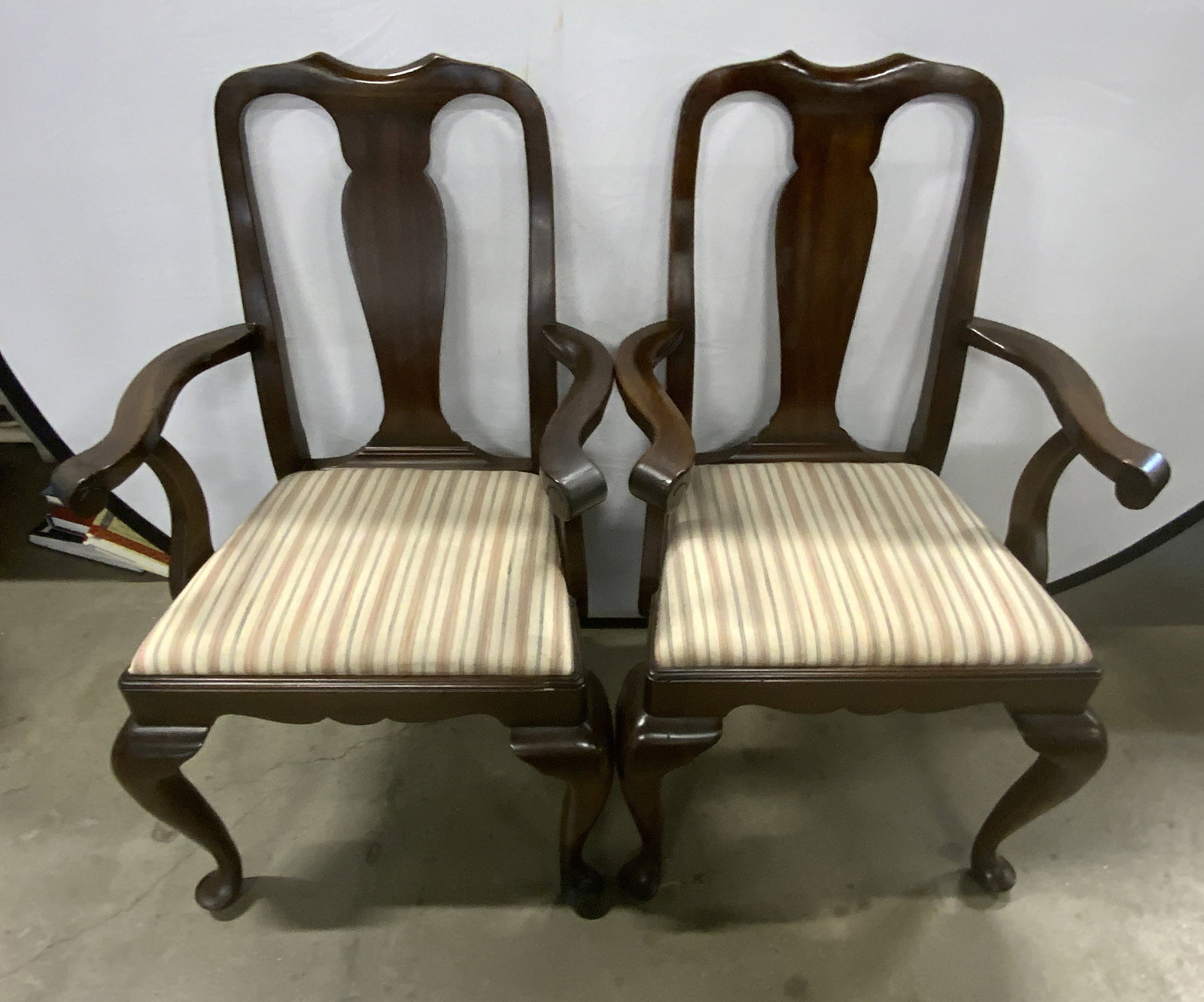 Pair Henkel Harris CO. Vintage Wooden Armchairs: A pair of vintage mahogany armchairs. Removable striped seat cushions. Raised stitching to the upholstery. Measures approx. 38.5H x 22.5W x 18D in. Measurement includes arms. Tag reads The Henkel Harr