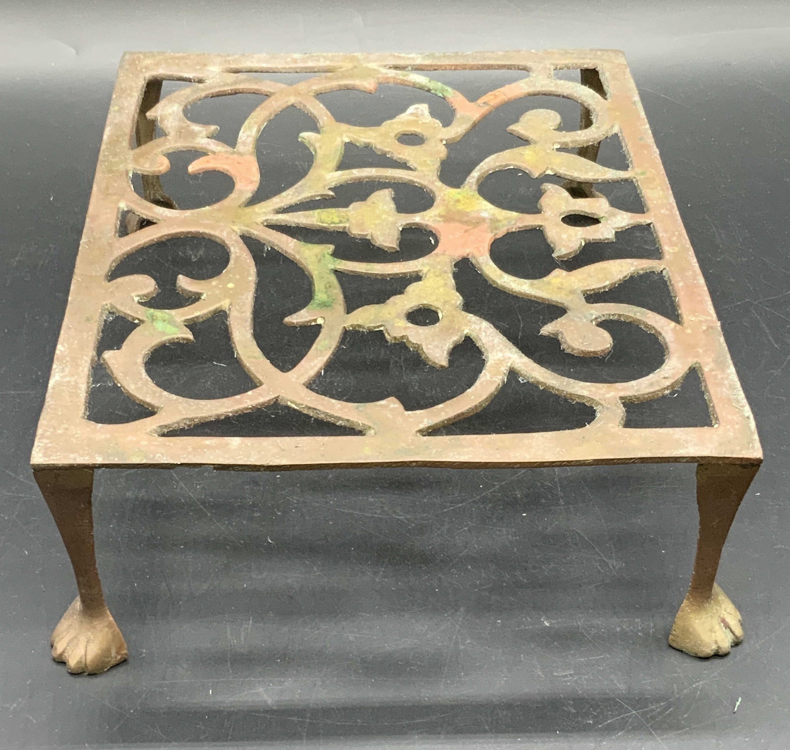 Vintage Open Metalwork Claw Foot Trivet: A vintage open metalwork trivet with clawed feet. Measures approx. 3H x 7.5W x 9D in. Some surface wear consistent with age, exposure, and use. Some residue present. Collectibles, Vintage Open Metalwo
