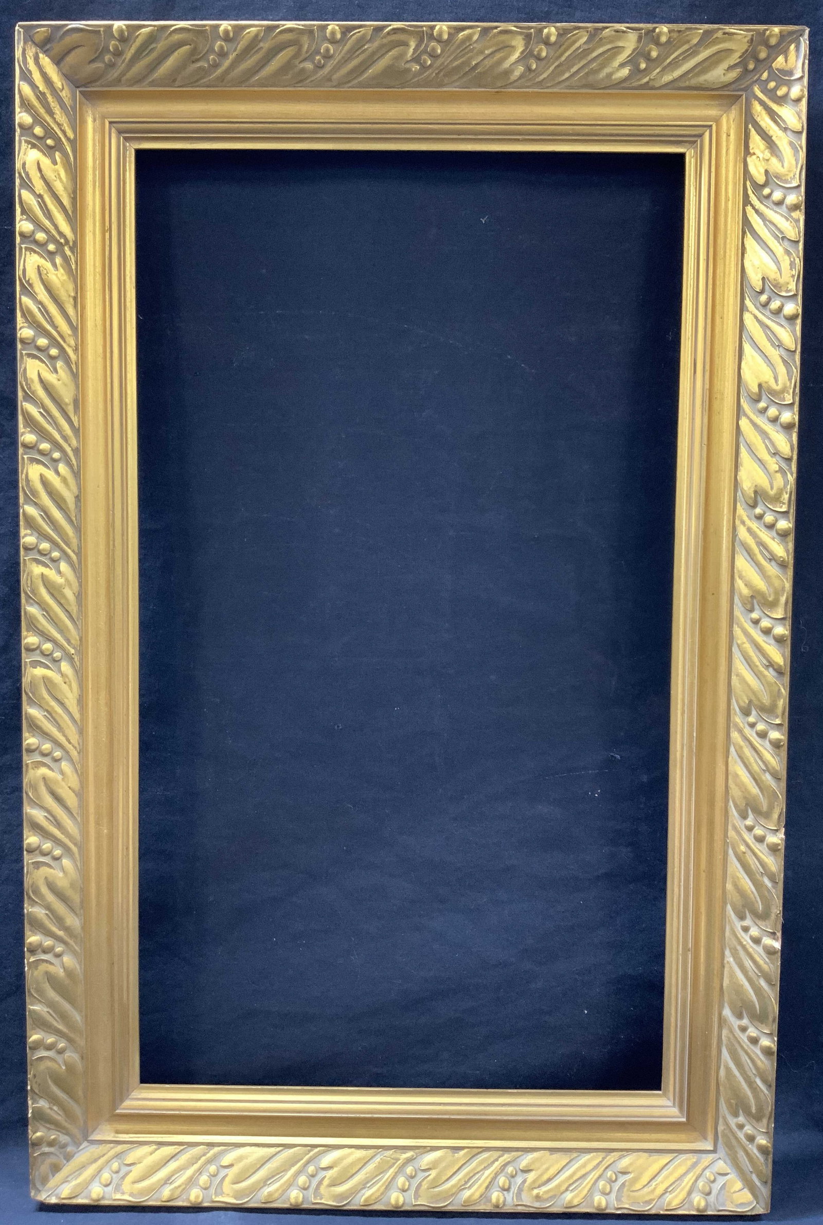 28.5 x 18.5 Inch Gold Leafed Wooden Frame, Belgium: Marked on backside Made in Belgium. Gold leafed wooden frame with leaf carved motifs on edges. Approximately 28.5 x 18.5 inches, window measures 24 x 13 inches. Made for a 24 x 12 inch artwork Moderat