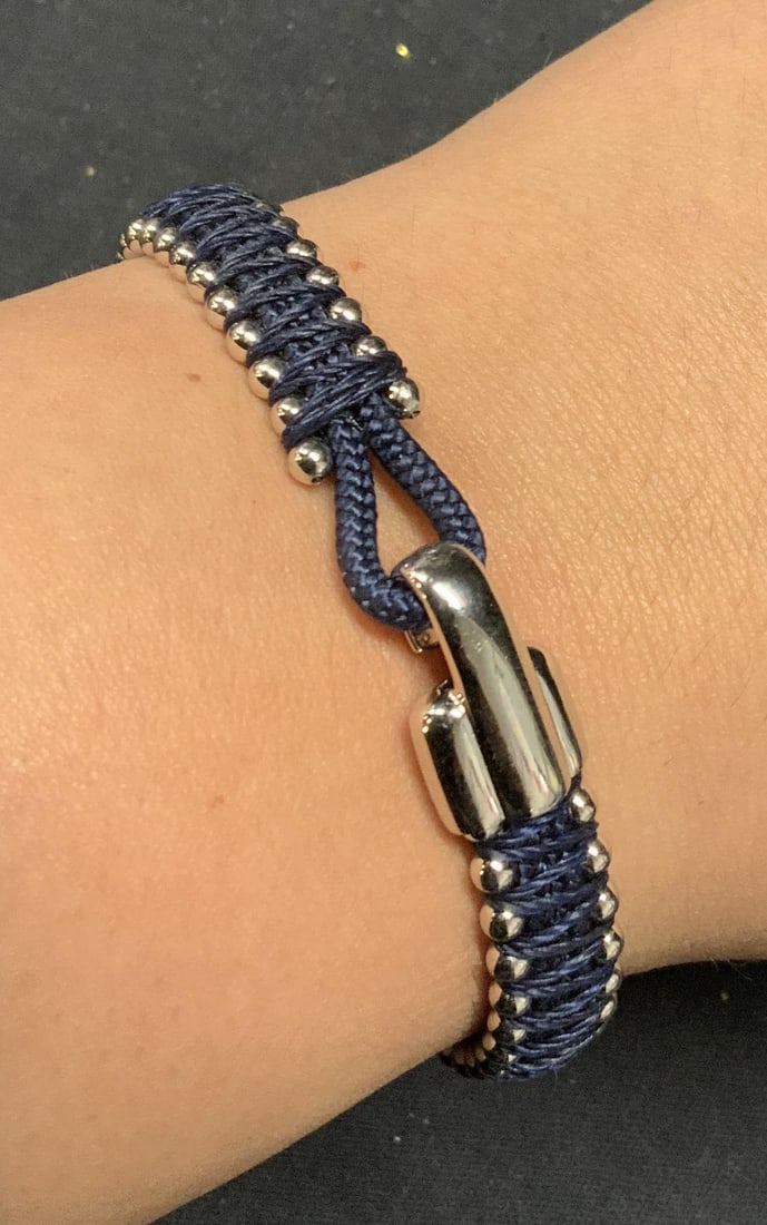 Miansai Sterling Silver Rope Bracelet: Miansai navy blue rope bracelet with sterling silver beads and clasp. Signed and marked 925 on clasp. Measures approx. 6.75 inches long. Total weight including rope .47 ozt. Some surface wear consiste