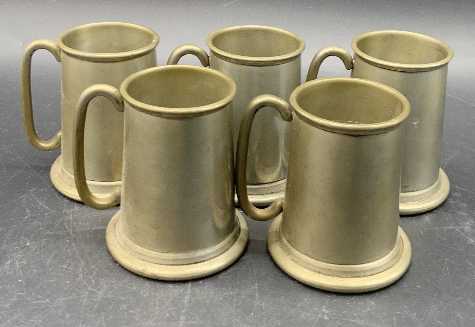 5 VINERS Sheffield English Pewter Demitasse Mugs: A set of 5 VINERS of Sheffield English Pewter demitasse mugs. Measures approx. 3H x 2.5W in. Measurement includes handle. Undersides marked VINERS of Sheffield English Pewter, MADE IN ENGLAND. Some de