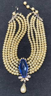 Schiaparelli Faux Pearl & Crystal Choker Necklace: Vintage Schiaparelli faux pearl multi strand necklace with blue toned crystal decoration and faux pearl pendant. Signed to underside. Some surface wear consistent with exposure. Measures approx. 14 in