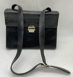 Bruno Magli Black Leather Handbag, Italy: Bruno Magli black leather handbag. Made in Italy. Designer label to interior metal plaque. Some wear to interior and exterior consistent with exposure. Measures approx. 11 x 3 x 8.25 inches.