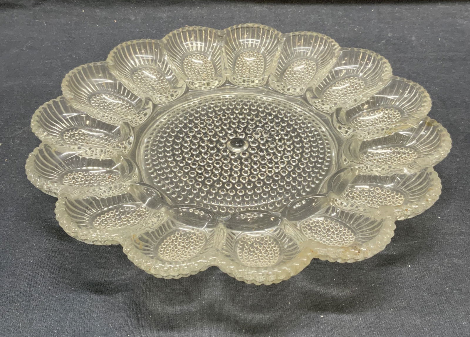 Heavy Glass Egg Dish: Heavy glass egg dish. Measures approx. 11.25 inches diameter. Some surface wear consistent with exposure. Egg dish, egg plate, glass egg dish, tableware, serving dish, table accessories, homewares, ho