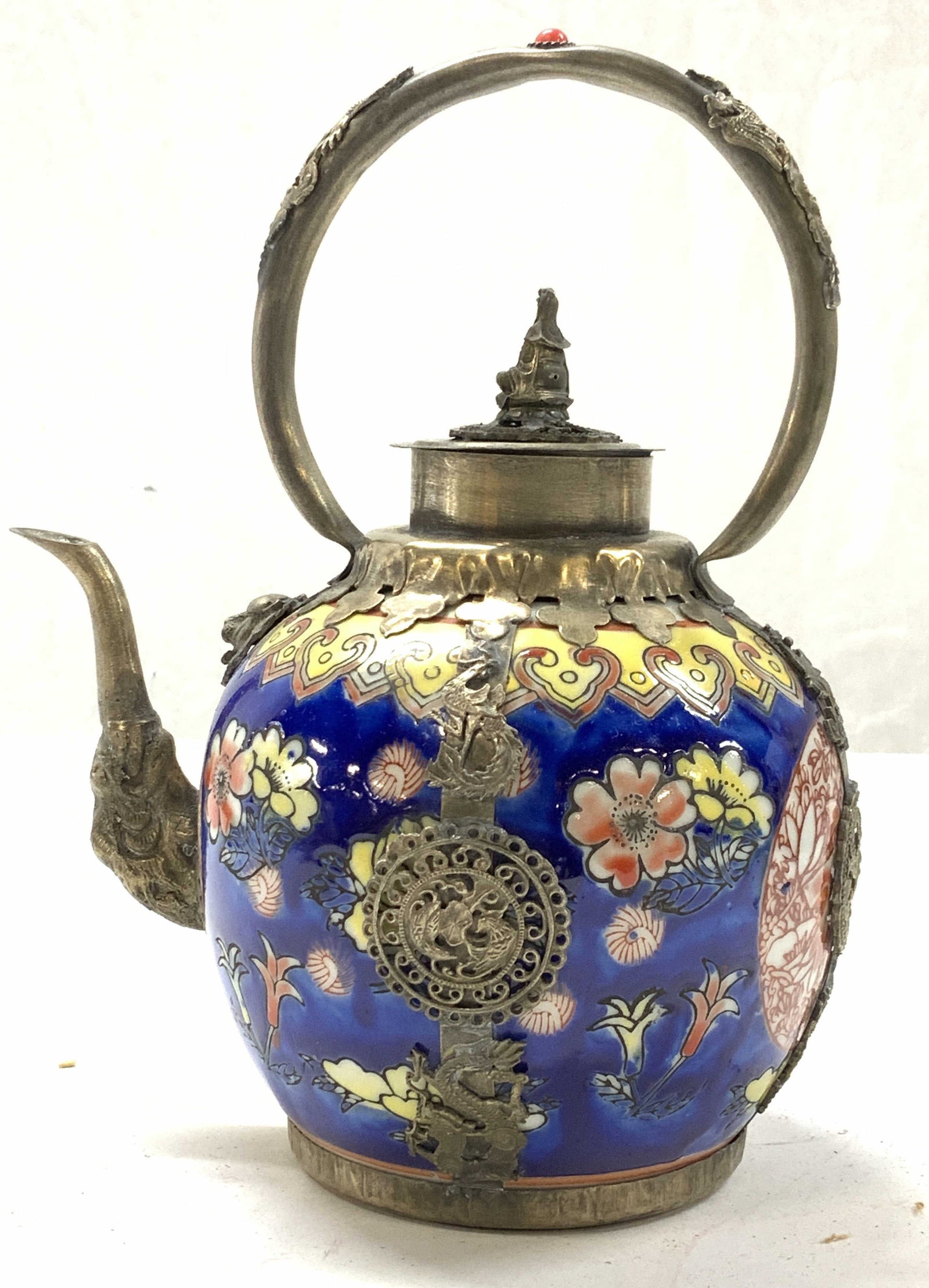 Carp-Dragon Asian Cobalt Porcelain Teapot: Hand painted porcelain teapot, cobalt blue with flowers and Leiwen thunder cloud border in yellow. Encased in hand crafted Tibetan silver decorated with Chinese dragons, Fenghuang Phoenix, lion head, 