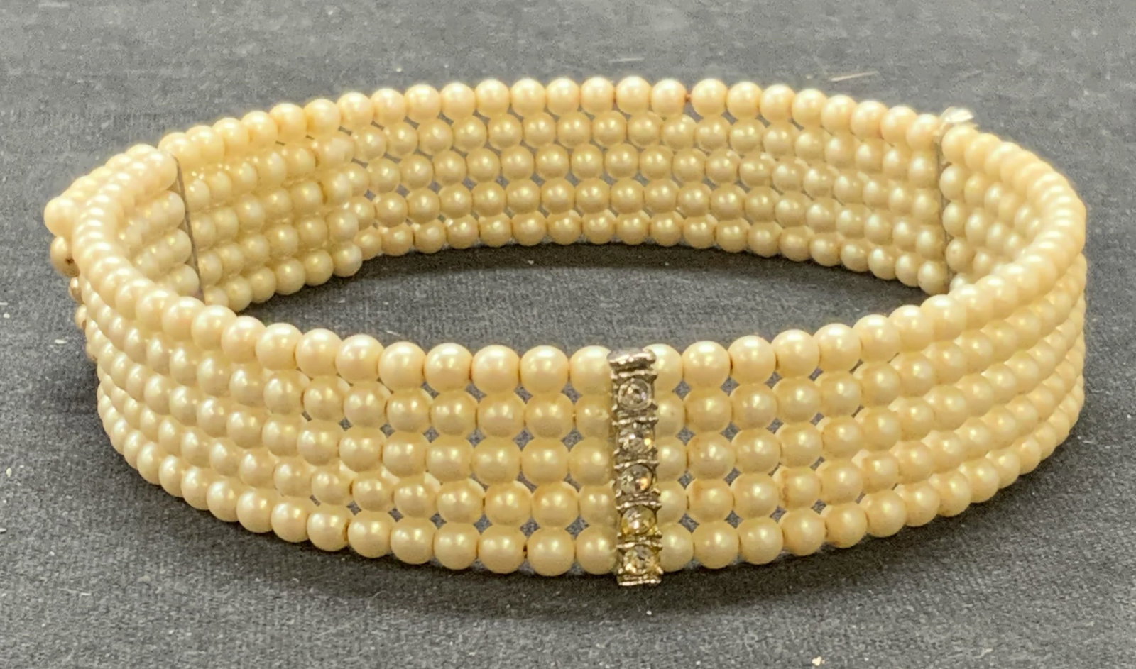 Faux Pearl & Crystal Choker Necklace: Faux pearl and crystal decorated multi strand choker necklace. Some surface wear consistent with exposure. Measures approx. 12.5 inches long, .75 inches wide across strands. Estate jewelry, costume je