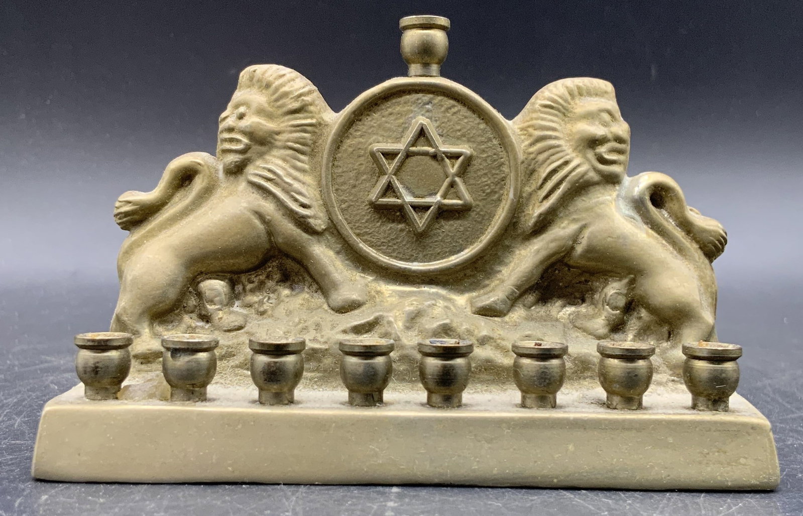 PARKWAY PRODUCTS Vintage Star of David Menorah: A vintage metal Star of David motif menorah. Two lions to either side of the Star of David. Raised metalwork details throughout the piece. Reverse signed PARKWAY PRODUCTS. Measures approx. 2.5H x 4W x