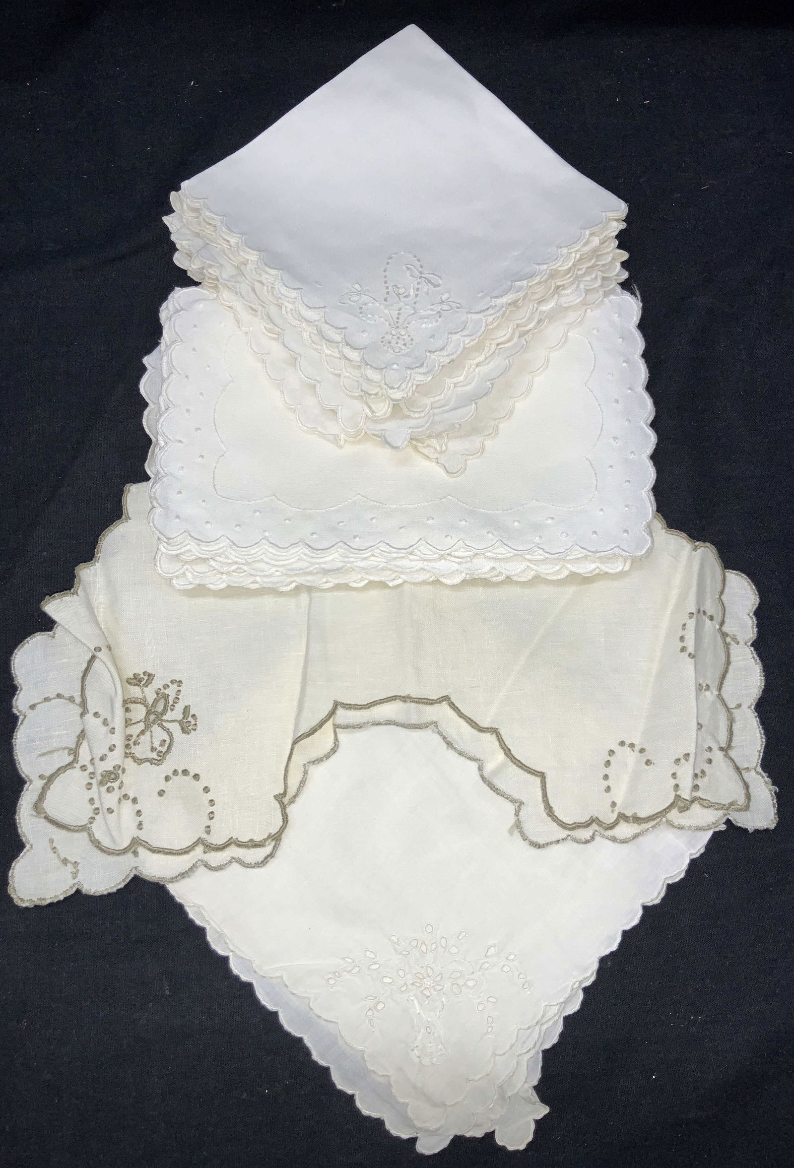 Lot 24 Vintage Embroidery Table Linens: Lot of 24 total table linens. 8 linens with scalloped edges and ribbon embroidered on corner, approximately 10.25 x 10 inches. 12 White scalloped stitched edges table doilies Approximately 5 x 7.5 inc
