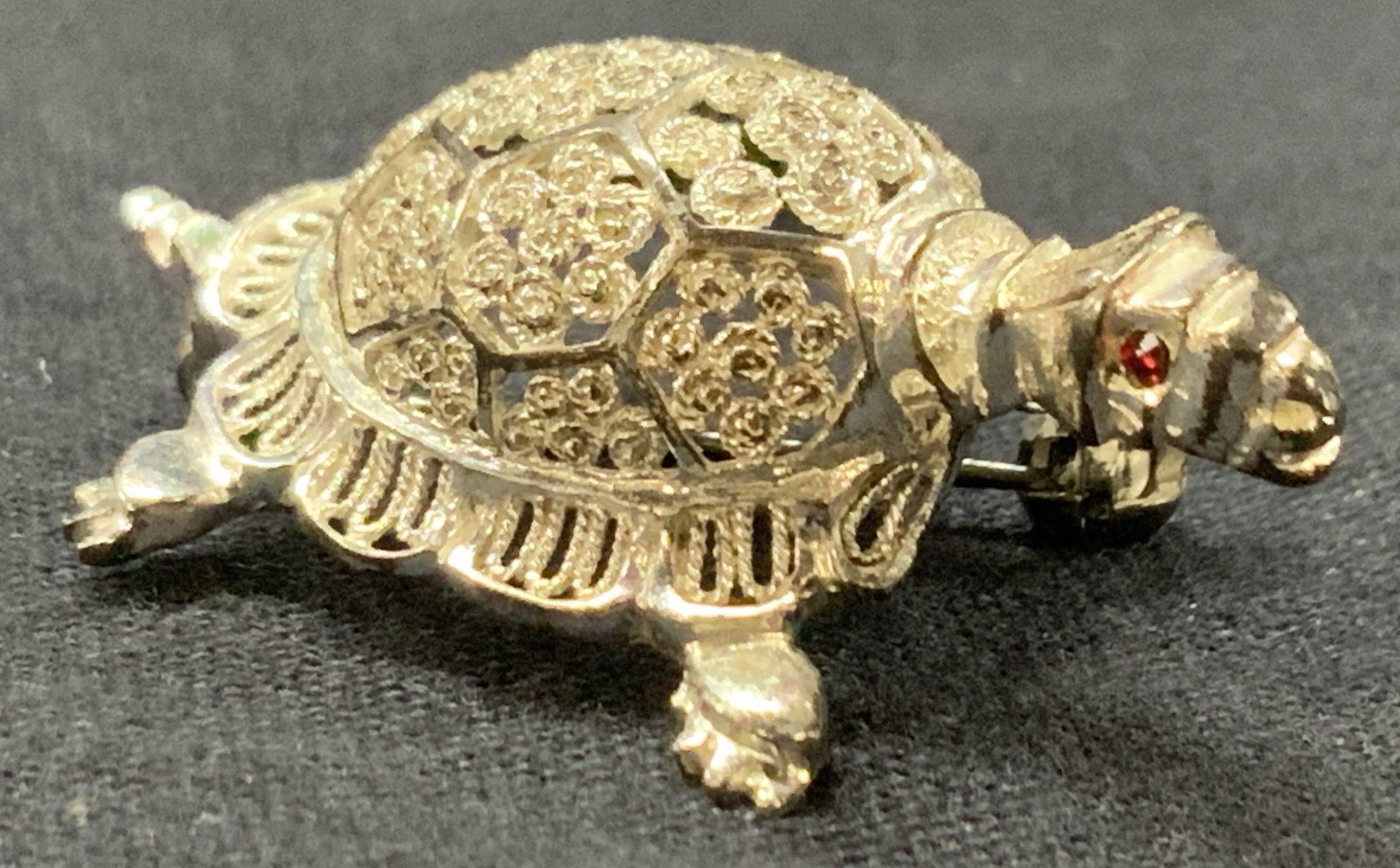 Stamped Sterling Filigree Style Turtle Brooch: Stamp in interior of shell, illegibly, marked sterling, Germany, A tortoise brooch with filigree style patterns on shell and red crystal eyes. Approximately 1.5 inches long. Total weight 0.17 ozt. Min