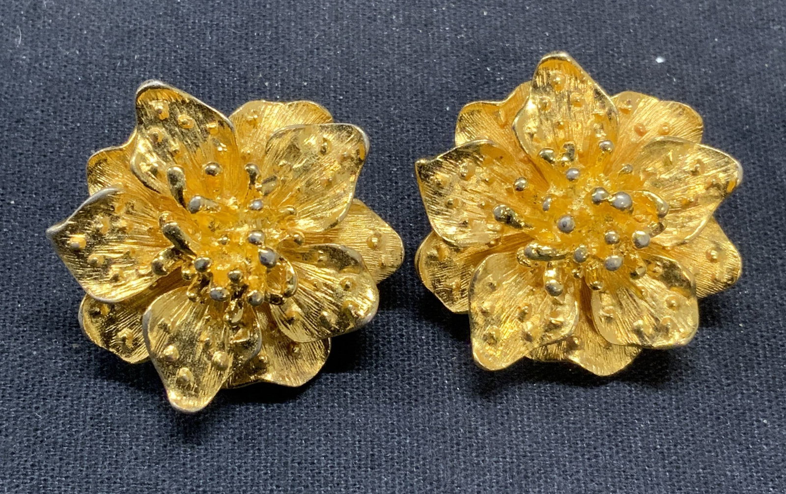 KJL KENNETH LANE Gold Tn Flower Earrings: Vintage KJL Kenneth Lane gold tone flower clip on earrings. Signed to backings. Some surface wear including scratching observed. Measure approx. 1.25 inches diameter. Estate jewelry, costume jewelry, 