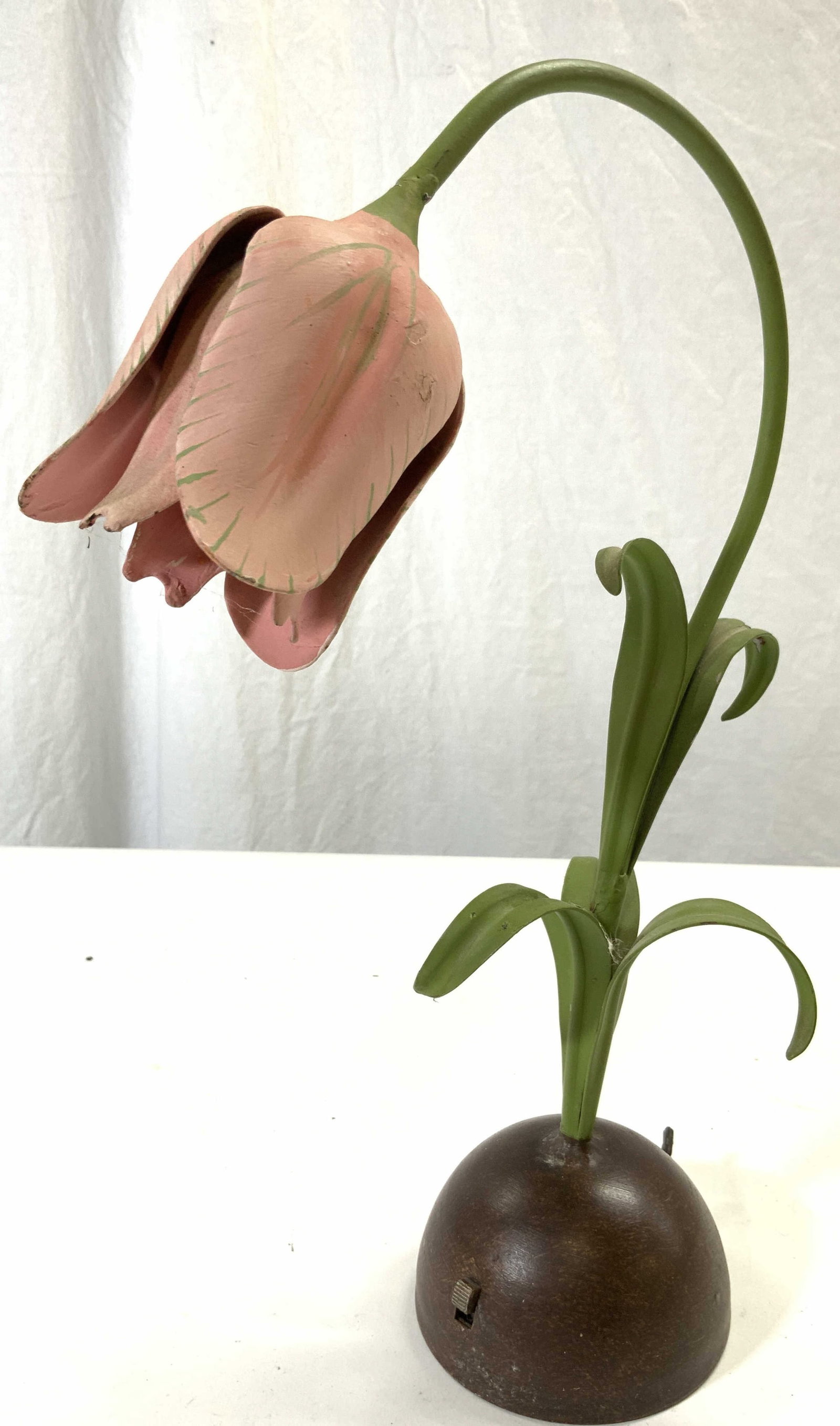 Vntg Painted Metal Tulip Table Lamp: Lamp is vintage. Piece is metal and appears to be hand painted with pink and green tones. Lamp has tulip shape with leaves on stem. Base is brown toned with dome shape. Piece measures approx 14 inches