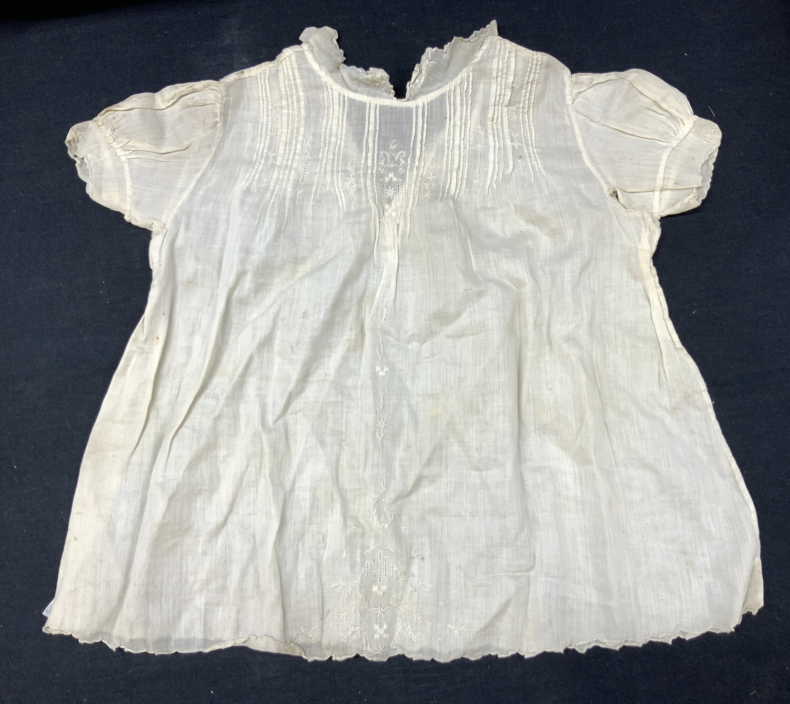 Antique Linen Baby Gown: Antique, possibly vintage white linen baby gown with button up collar. Approximately 17 inches off from collar to end of dress, sleeves measure 4 inches long and measures 12 inches wide at the chest.