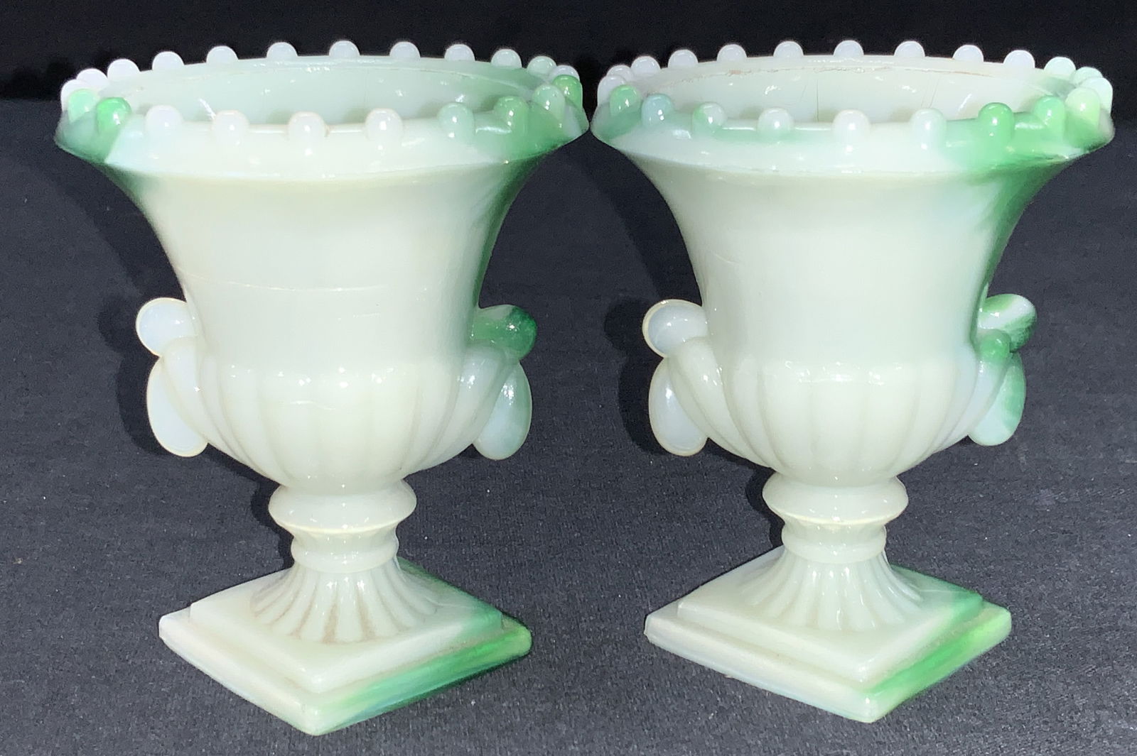 2 Arko Agate Swirl Slag Glass Vessels: Pair of arko agate green swirl slag glass vessels made of resemble Greek style goblets with ribbed rims. Fluoresces under UV Black light Approximately 3.25 inches tall. Moderate wearing to rims. Vinta
