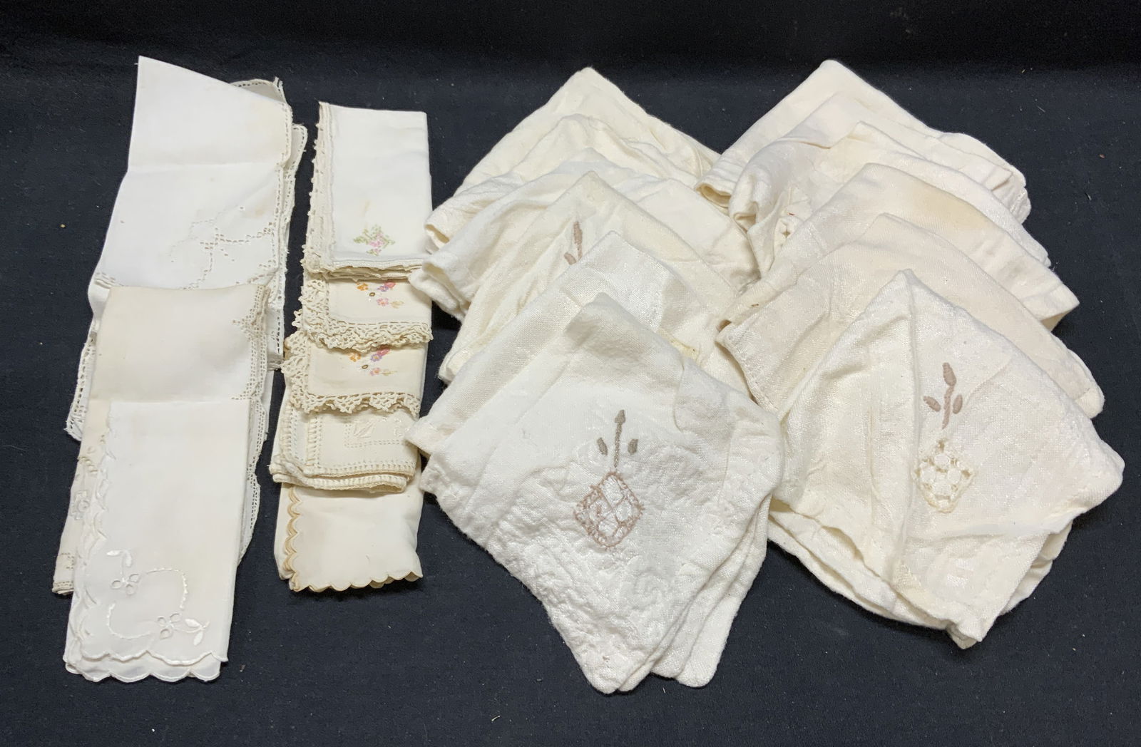 Group 22 Cream Ted Cocktail Napkins: Group lot of 22 pieces cream toned cocktail napkins. Some pieces with lace and embroidered decoration. All pieces have wear to material consistent with exposure including blemishes. Largest piece meas