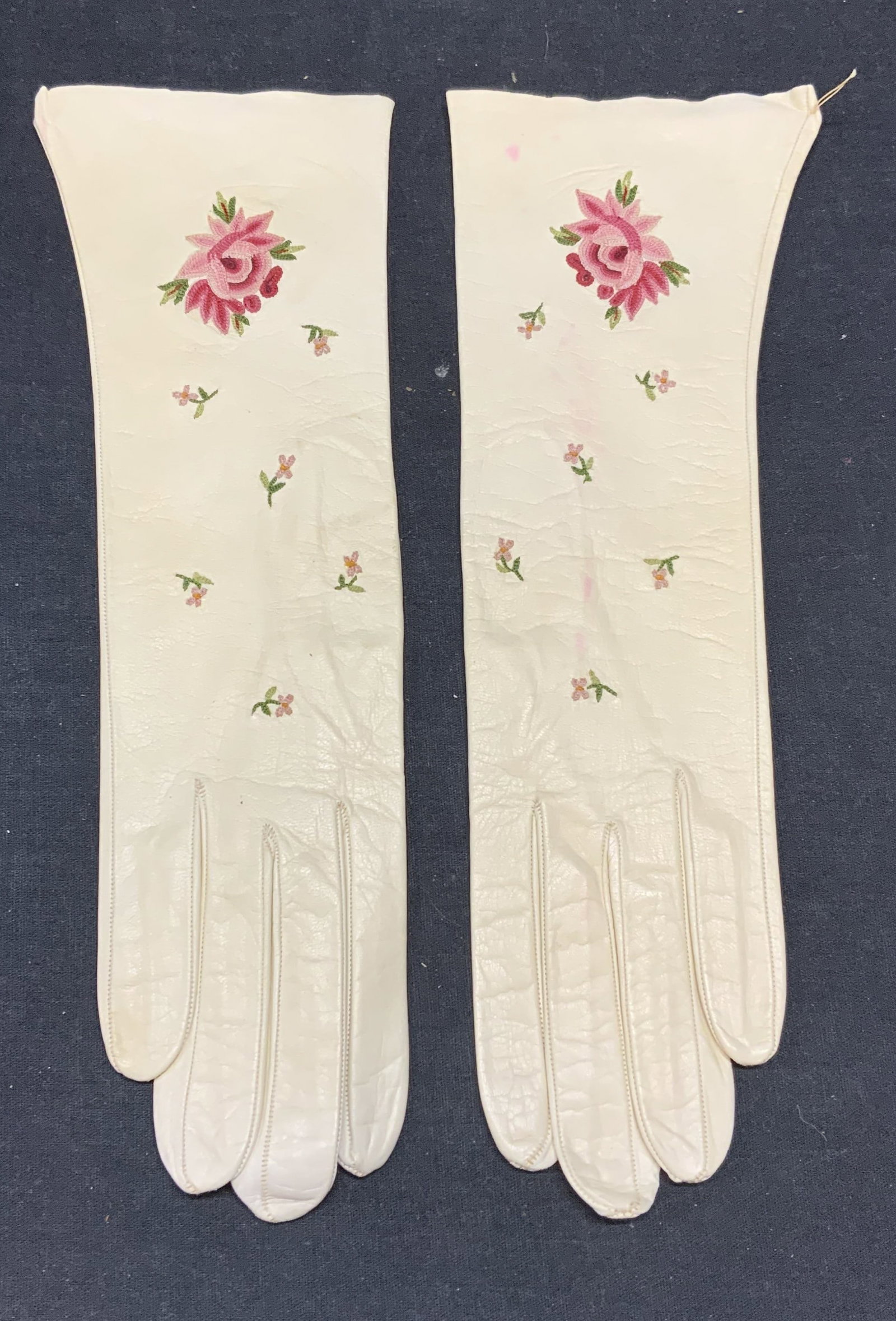 Vintage Lavable White Leather Floral Gloves: Vintage Lavable white leather gloves with embroidered floral detail. Some wear consistent with exposure including blemishes. Designer label to interior. Measure approx. 11.25 x 2.75 inches. Lavable, L