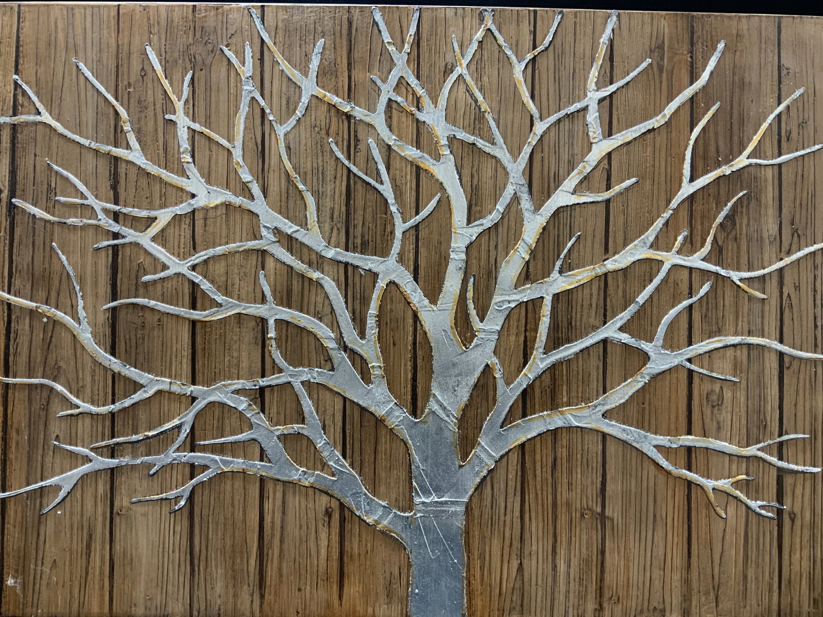 31 x 47 Inch Silver Tn Tree Canvas: A canvas with wood toned textured panels with a silver toned tree affixed over the wooden Imagery. No frame Approximately 31.5 x 47.5 inches. Evident wearing to tree throughout and wearing to edges of