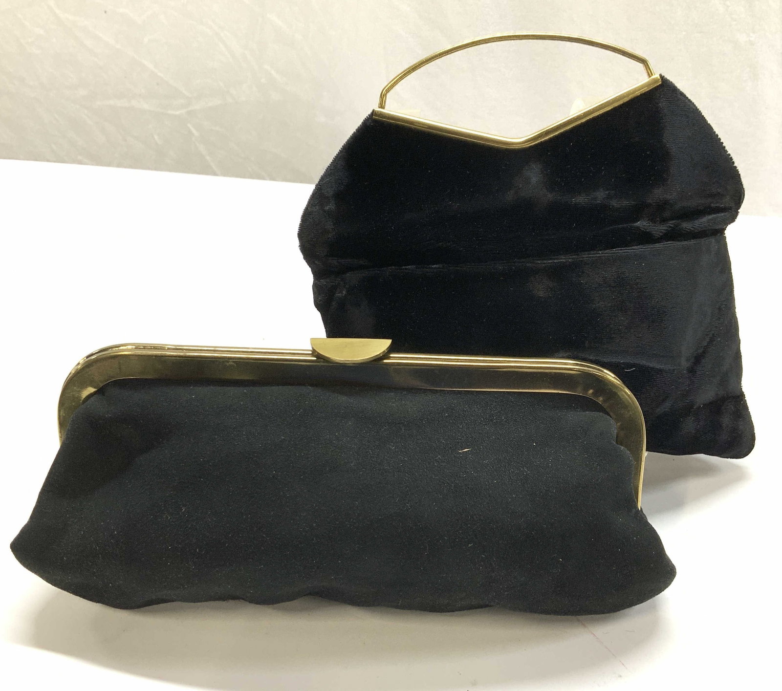 2 Suede Style & Velvet Evening Bags: Black evening bags/ specialty bags. One Suede style with gold tone frame, measures 10 x 5 in. Opens wide, can fit a cell phone, some make up, keys and ID/ CC Wallet. Both unlabeled. Velvet handbag wit