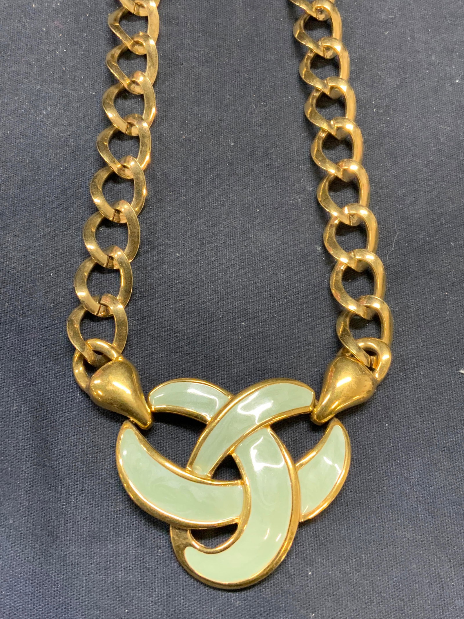 NAPIER Gold Tone Green Enamel Pendant Necklace: Napier gold tone necklace with green enameled pendant. Signed on clasp and underside of pendant. Total length of necklace approx. 22.5 inches. Drop length approx. 11 inches. Pendant measures approx. 2