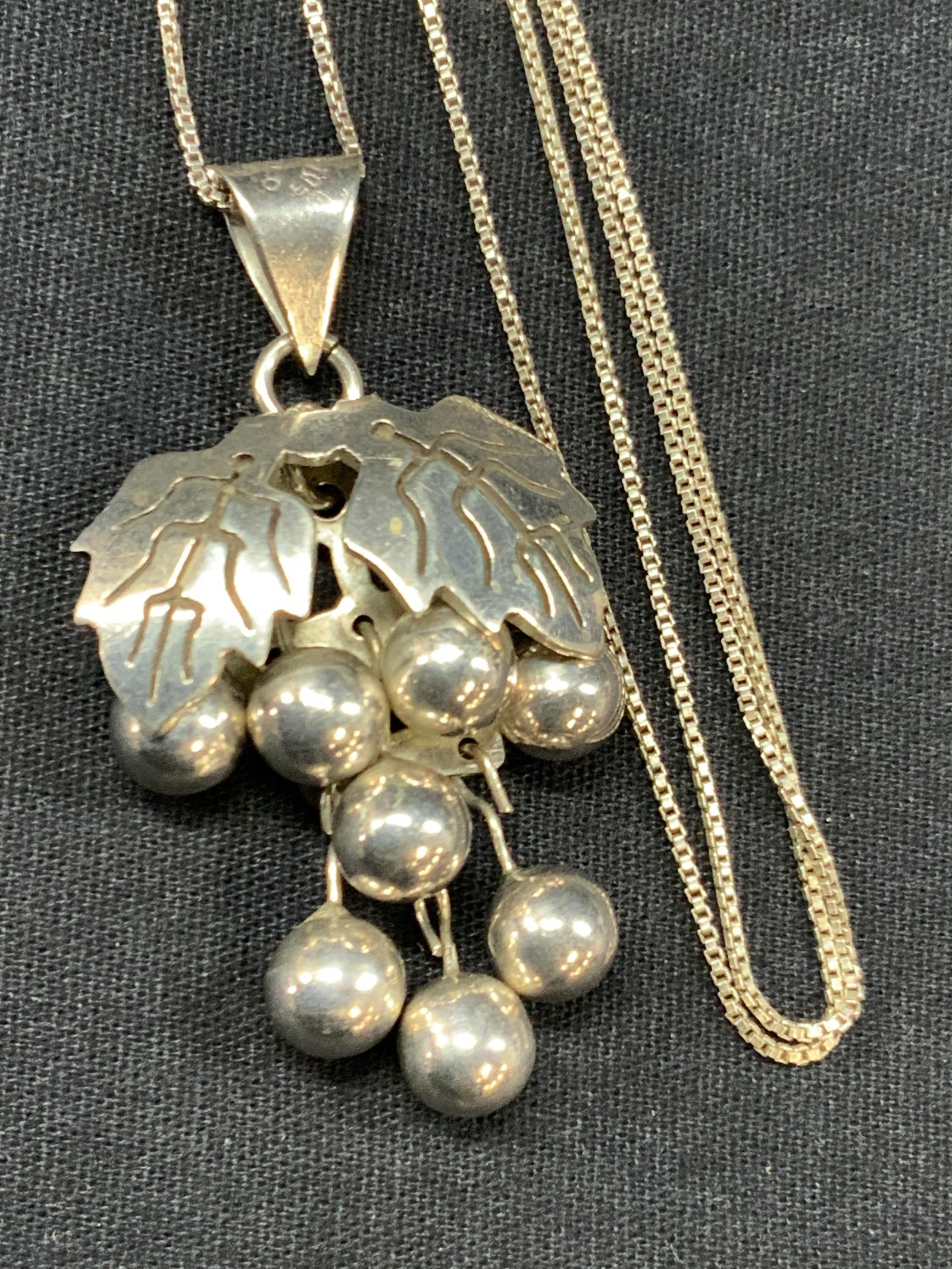 Sterling Silver Grape Bunch Necklace Italy, Mexico: Sterling silver necklace with necklace being marked Italy 925 on clasp. Pendant of grapes is stamped JT, Mexico, 925 on jump ring. Pendant has individual grape on its own post so it can move independe