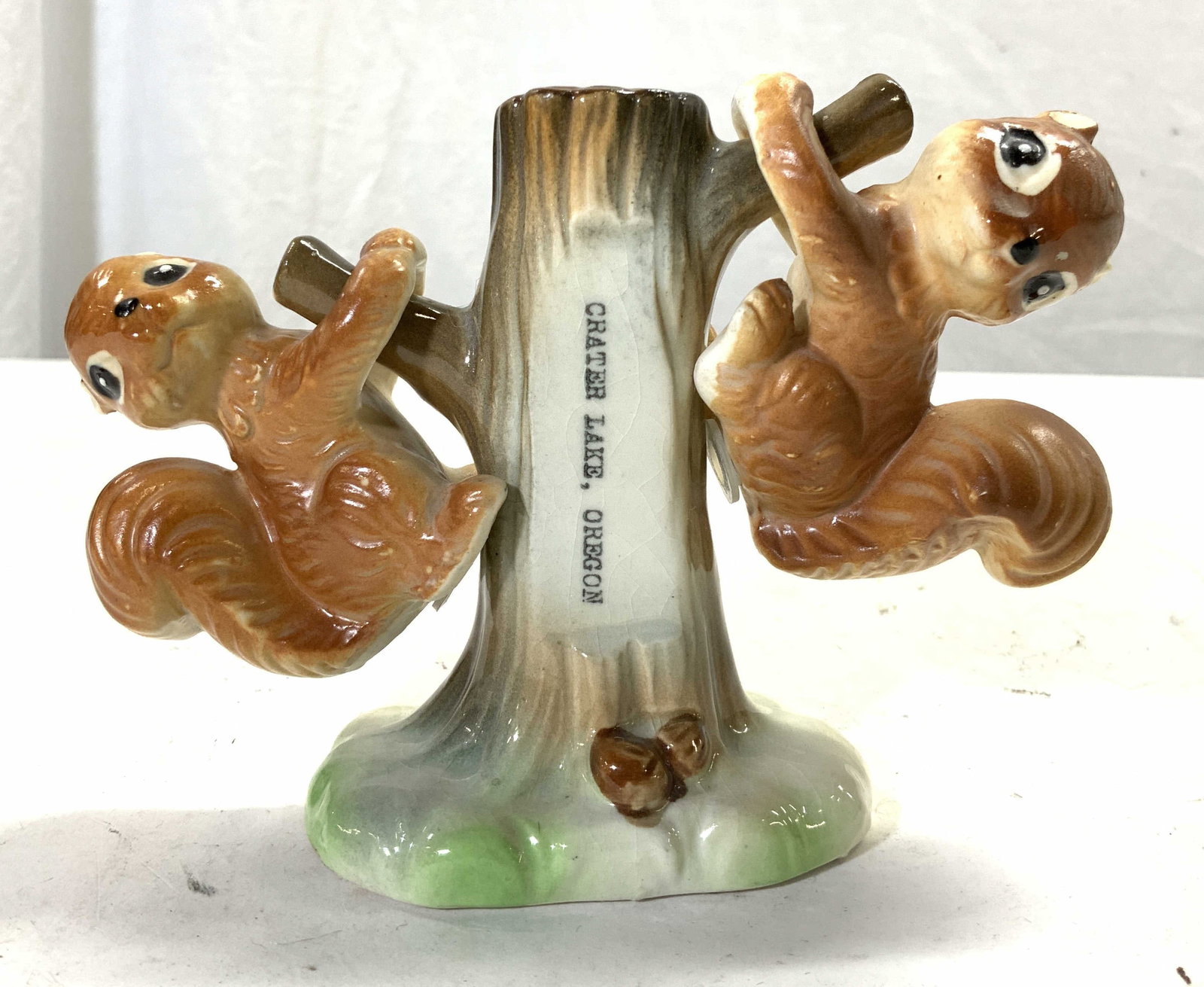 EFCCO Vtg Porcelain Squirrel Salt & Pepper Shakers: Tag on Underside reads EFCCO. Piece marked CRATER LAKE OREGON. Pieces are vintage and porcelain. Includes 2 squirrel shaped shakers which hang from tree figure. When all together measures approximatel