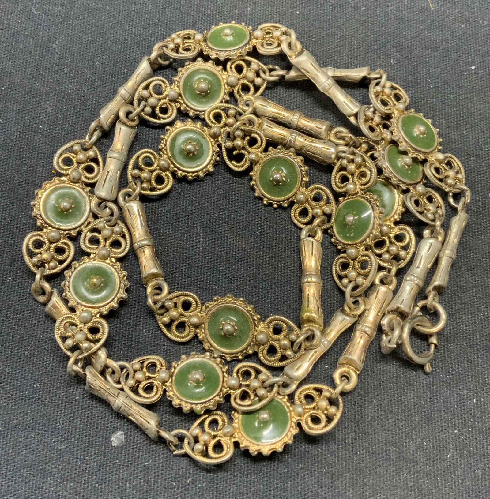 Silver & Gold Tone Green Enamel Necklace: Silver and gold toned necklace with green enamel decoration. Drop length approx. 14 inches. Surface wear including tarnishing and scratching observed. Estate jewelry, costume jewelry, cocktail jewelry