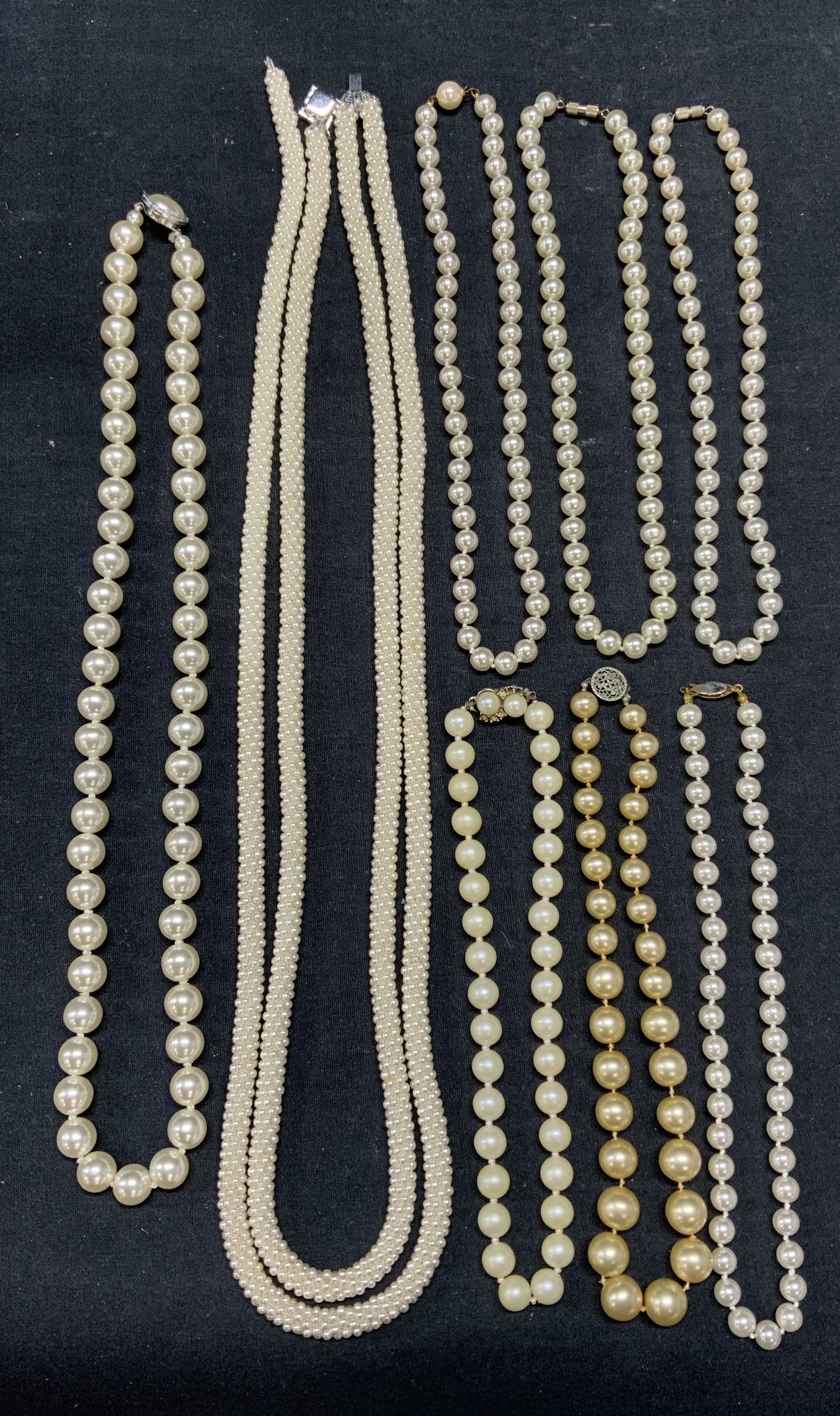 Lot 8 Vintage Faux Pearl Necklaces: Lot of 8 vintage faux pearl necklaces. All pieces have surface wear including scratching observed. Double strand faux seed pearl necklace needs repair. Lengths vary, longest necklace drop length appro