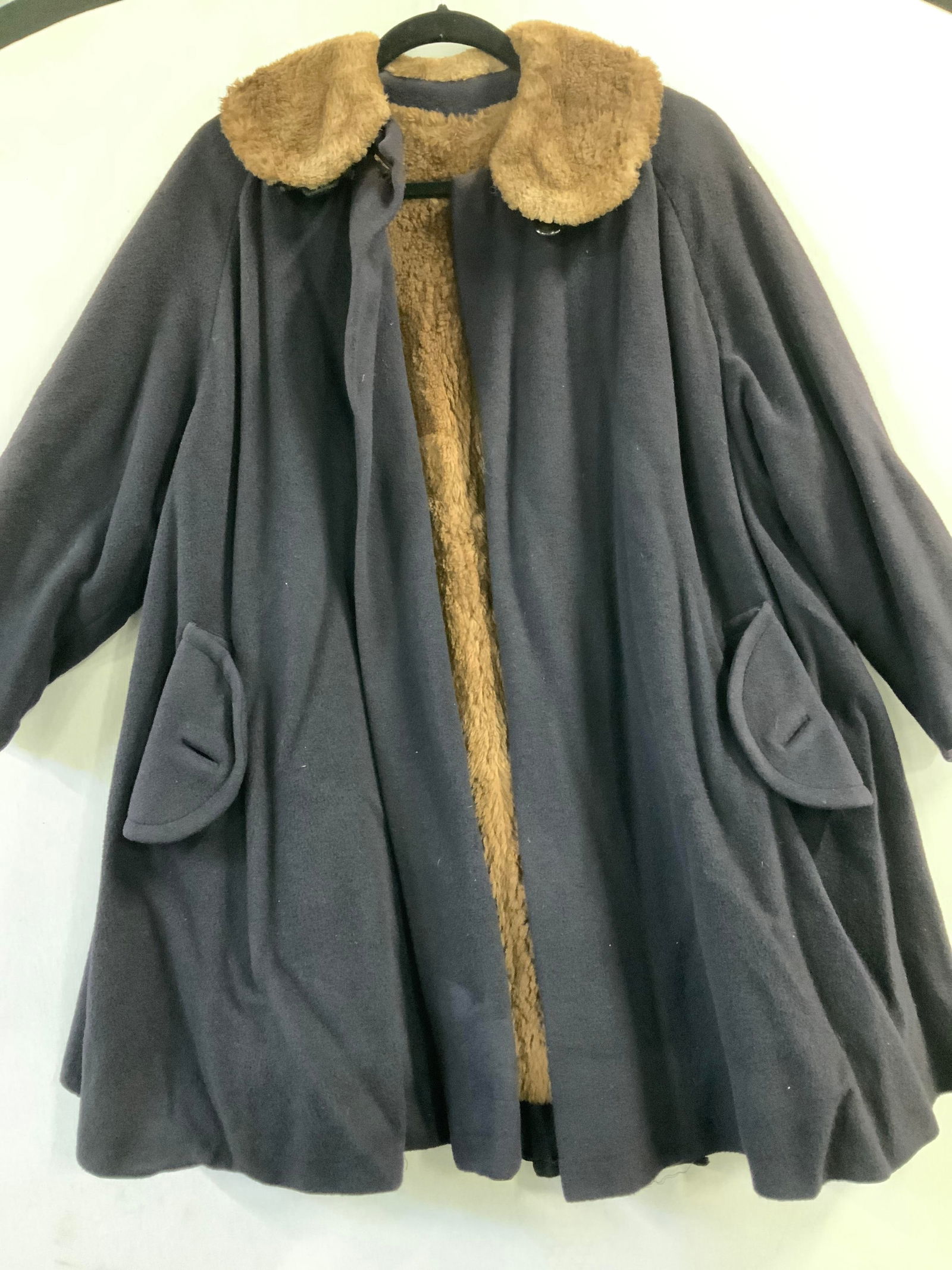 Vintage Plush Swing Coat: Polartec style fabric swing coat with brown faux fur collar and interior lining. 34 in. L . 54+ waist/ hips. Lining must be repaired. Buttons needed to fasten hand pocket flap. Black, almost looks nav